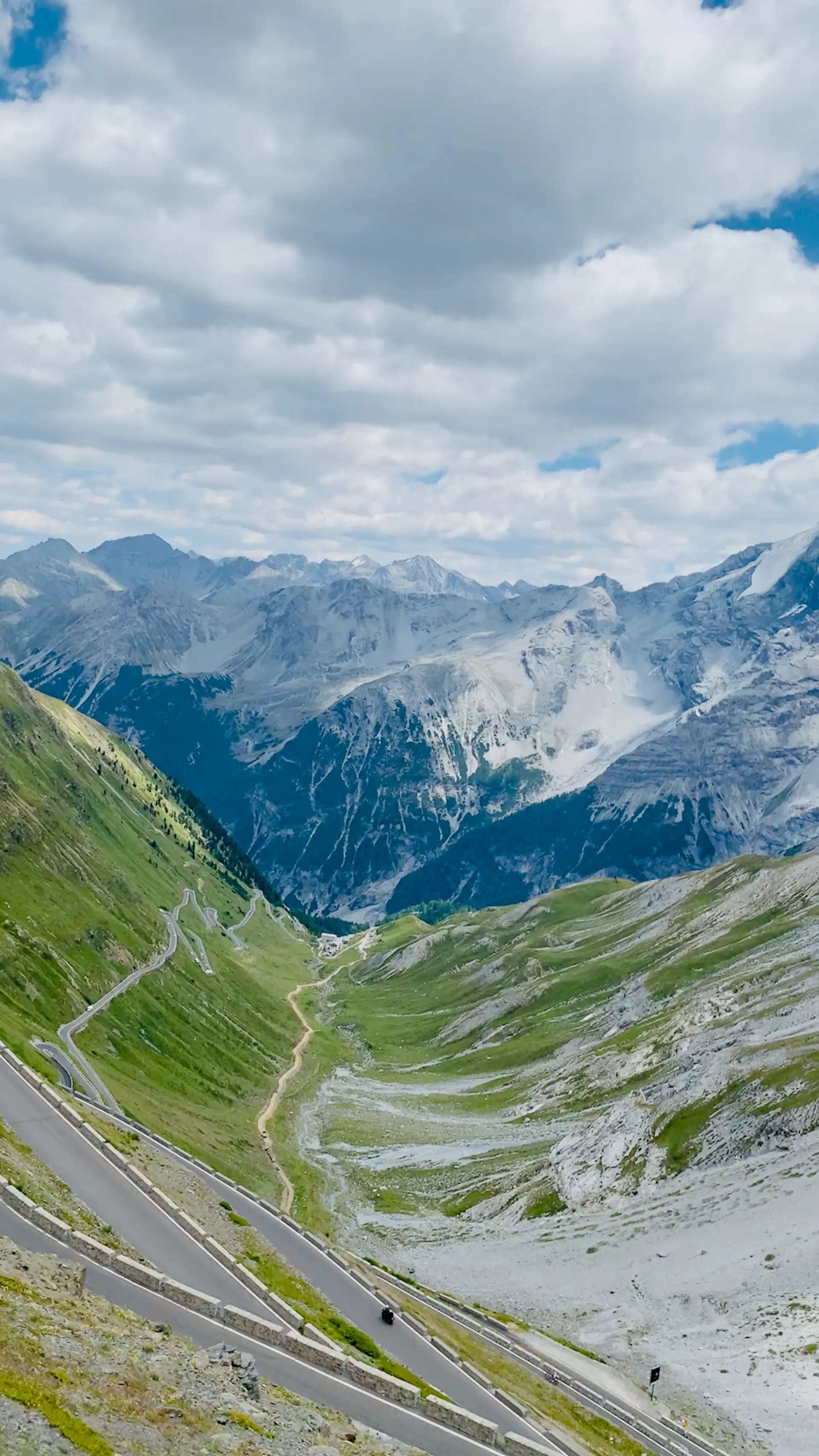 A luxury car ascending the hairpin bends of the Stelvio Pass