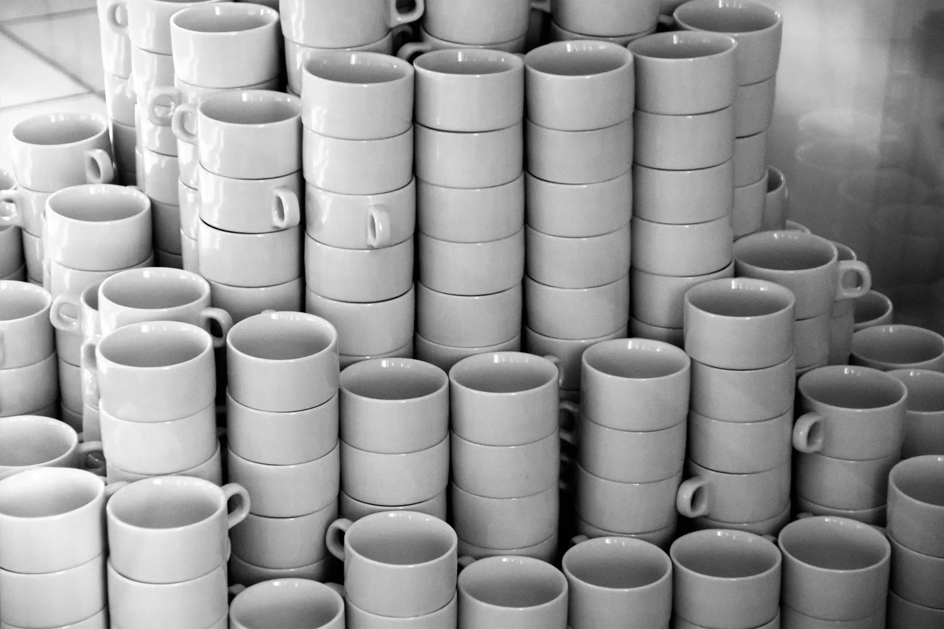Detail of espresso machine and stacked porcelain cups