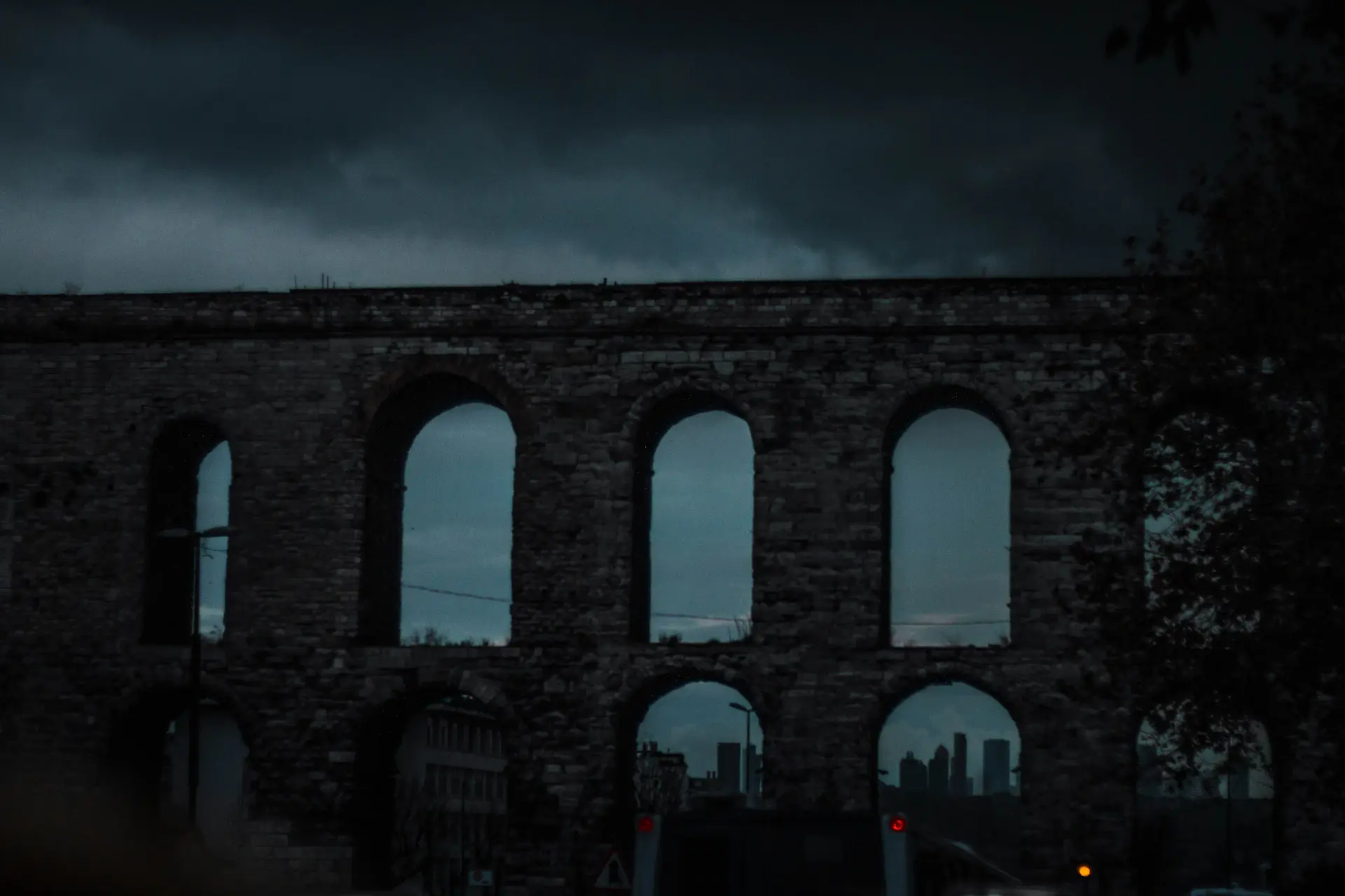 A historic stone distillery facade at dusk