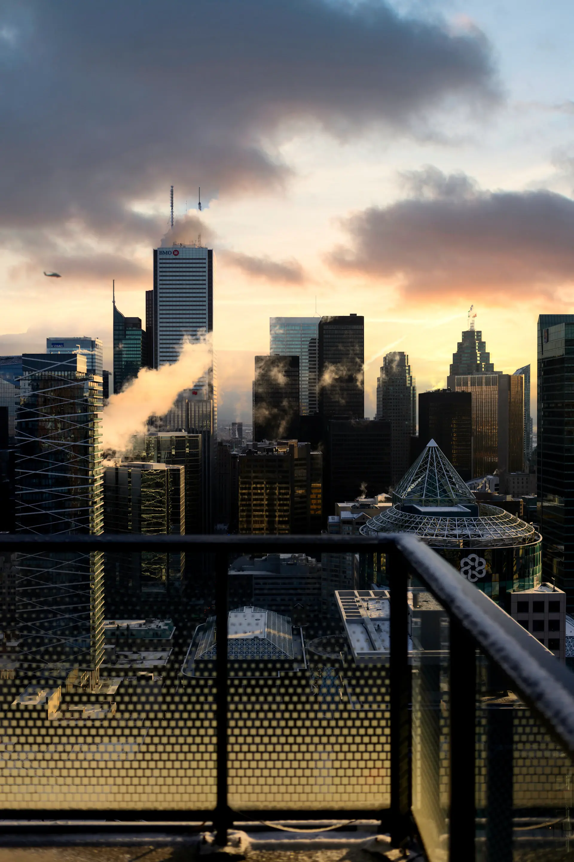 Penthouse terrace overlooking the city skyline at dusk