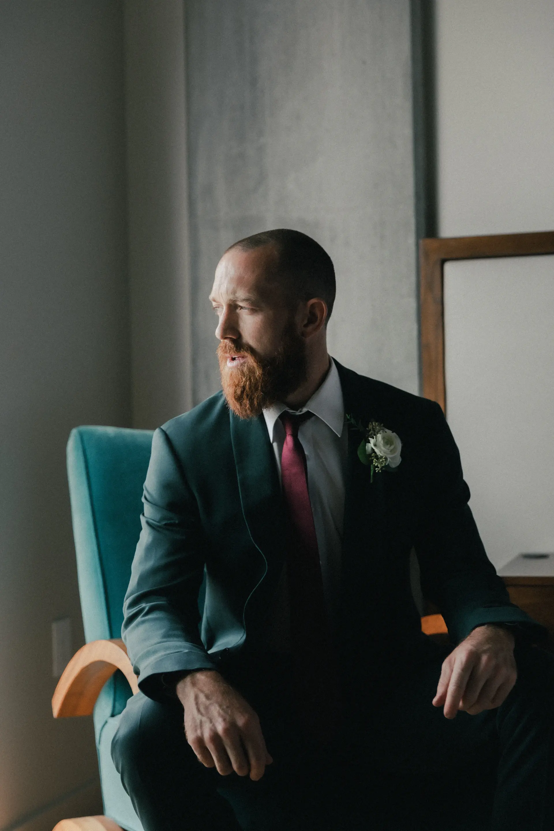 A groom in elegant attire turning to meet his bride
