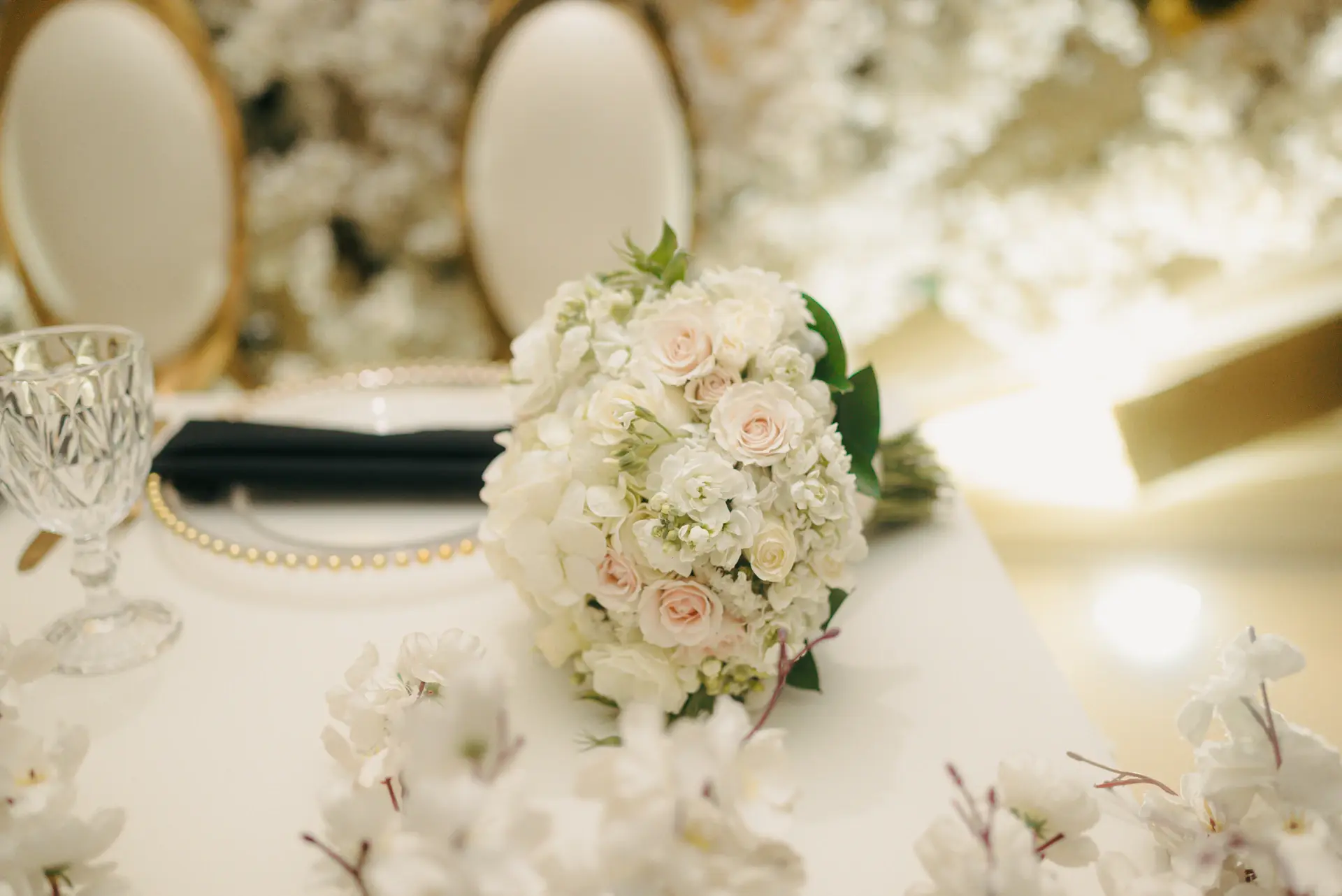 Bridal bouquet of ivory roses on a velvet chair