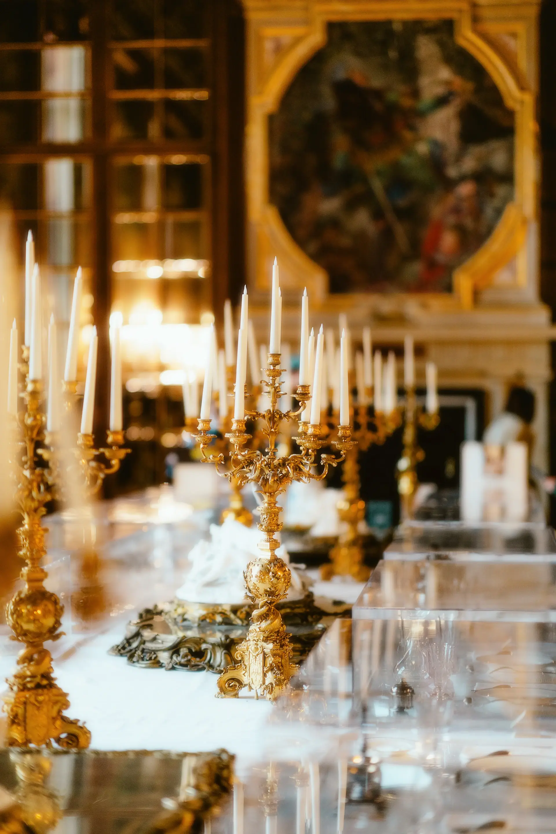 Tall taper candles in golden holders