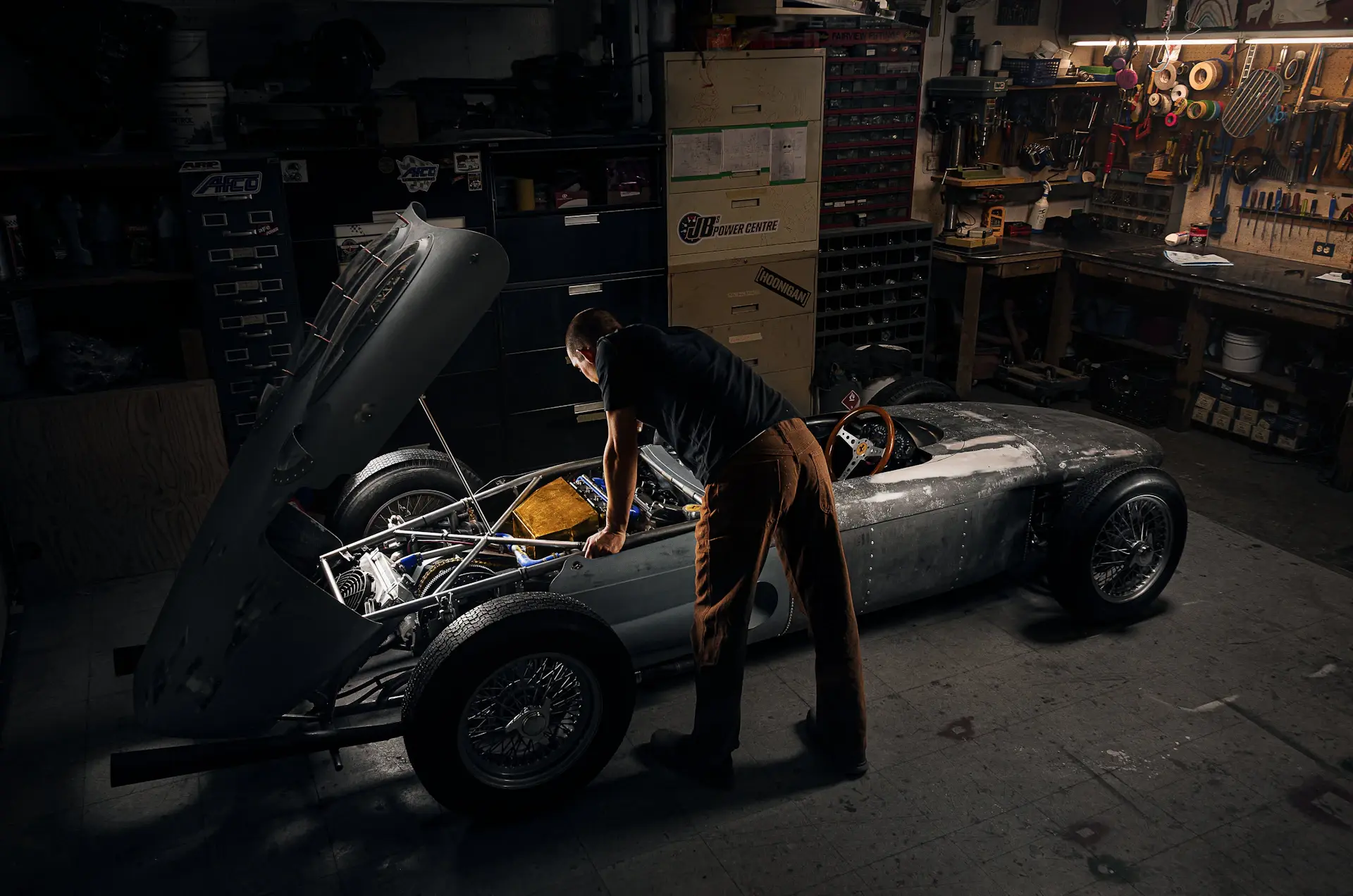 Artisans hand-building a luxury motorcar in a quiet workshop
