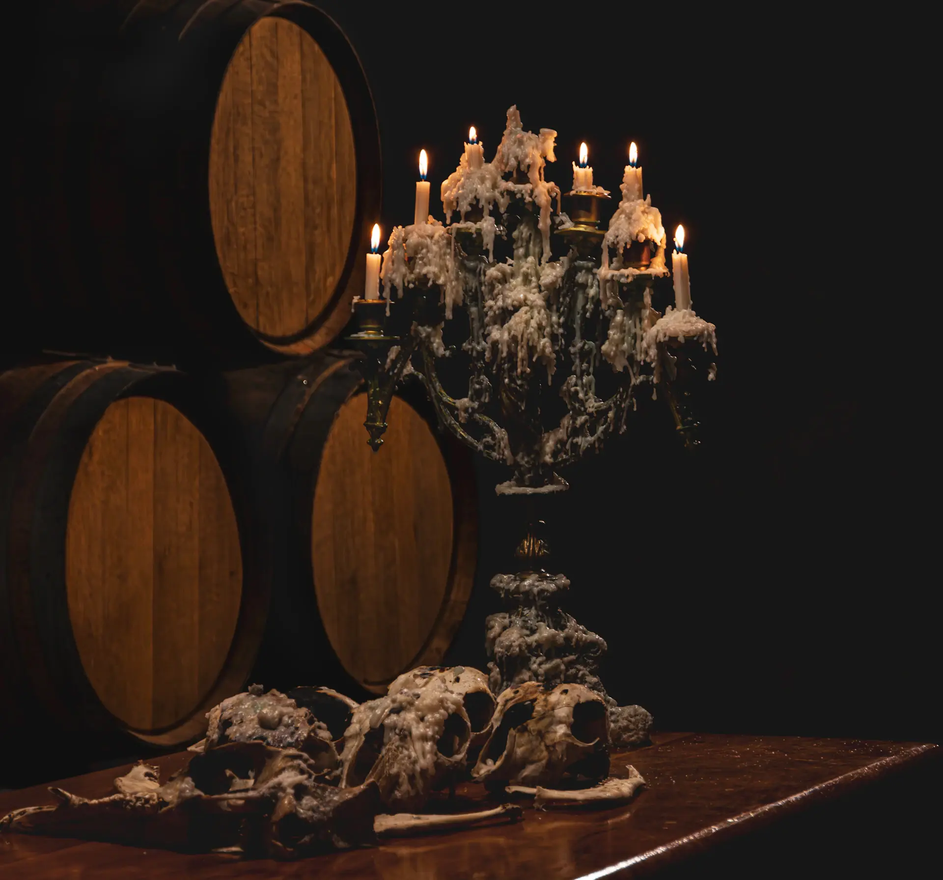 Vintage portrait of the founder inspecting a wine barrel in the original cellar