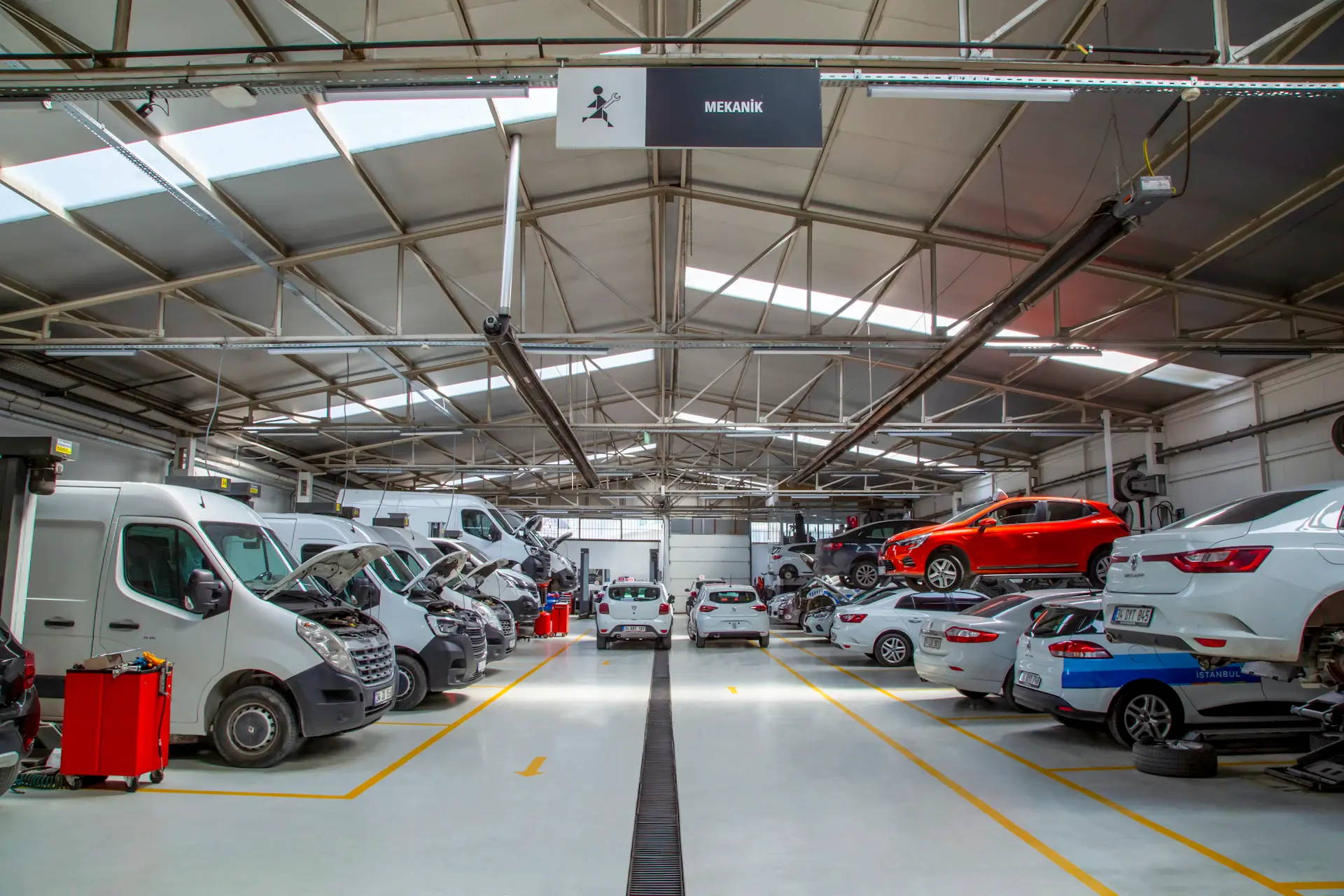 Bare luxury car chassis on the atelier bench under directional light