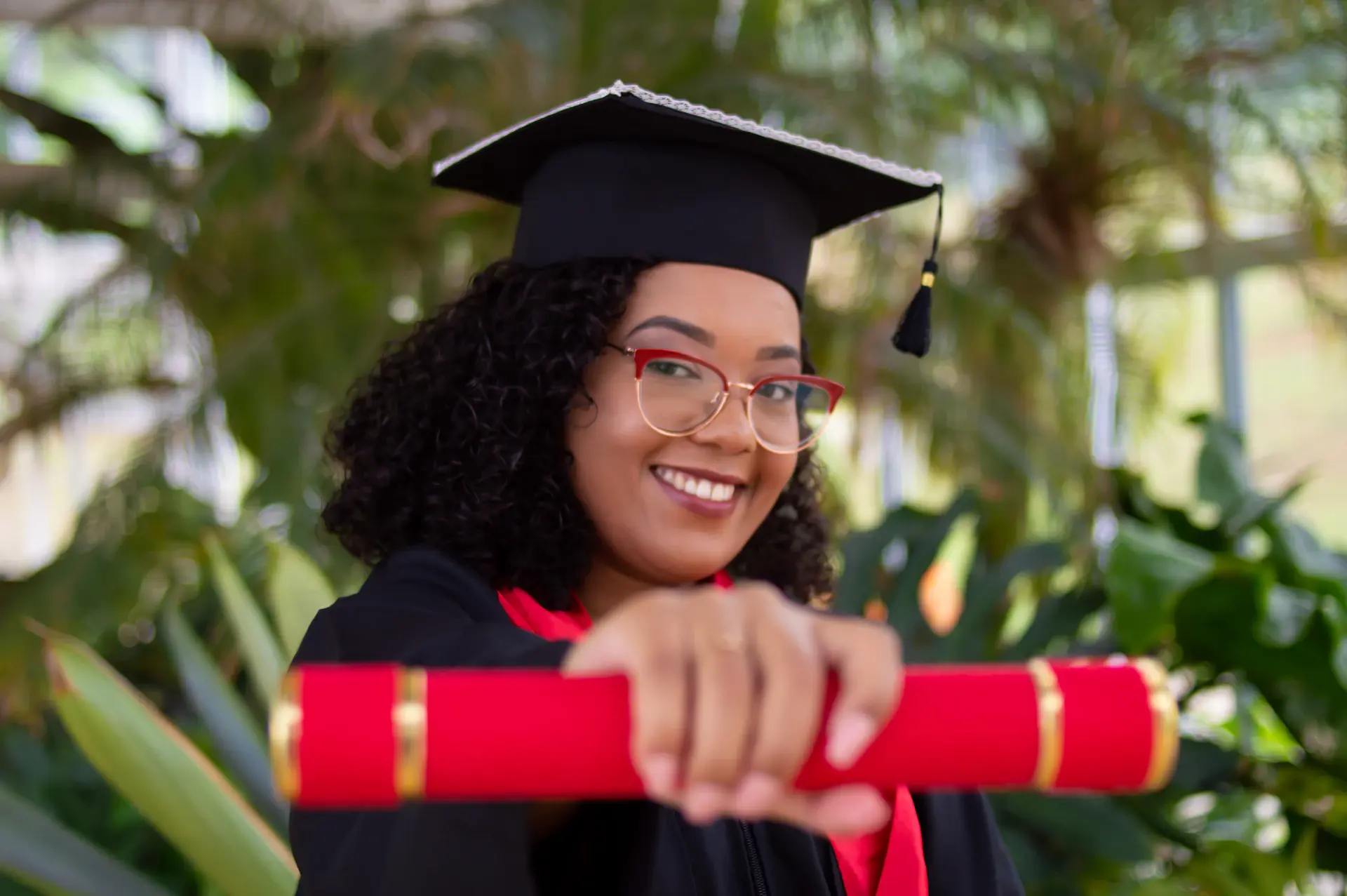 Graduate holding a scholarship award certificate