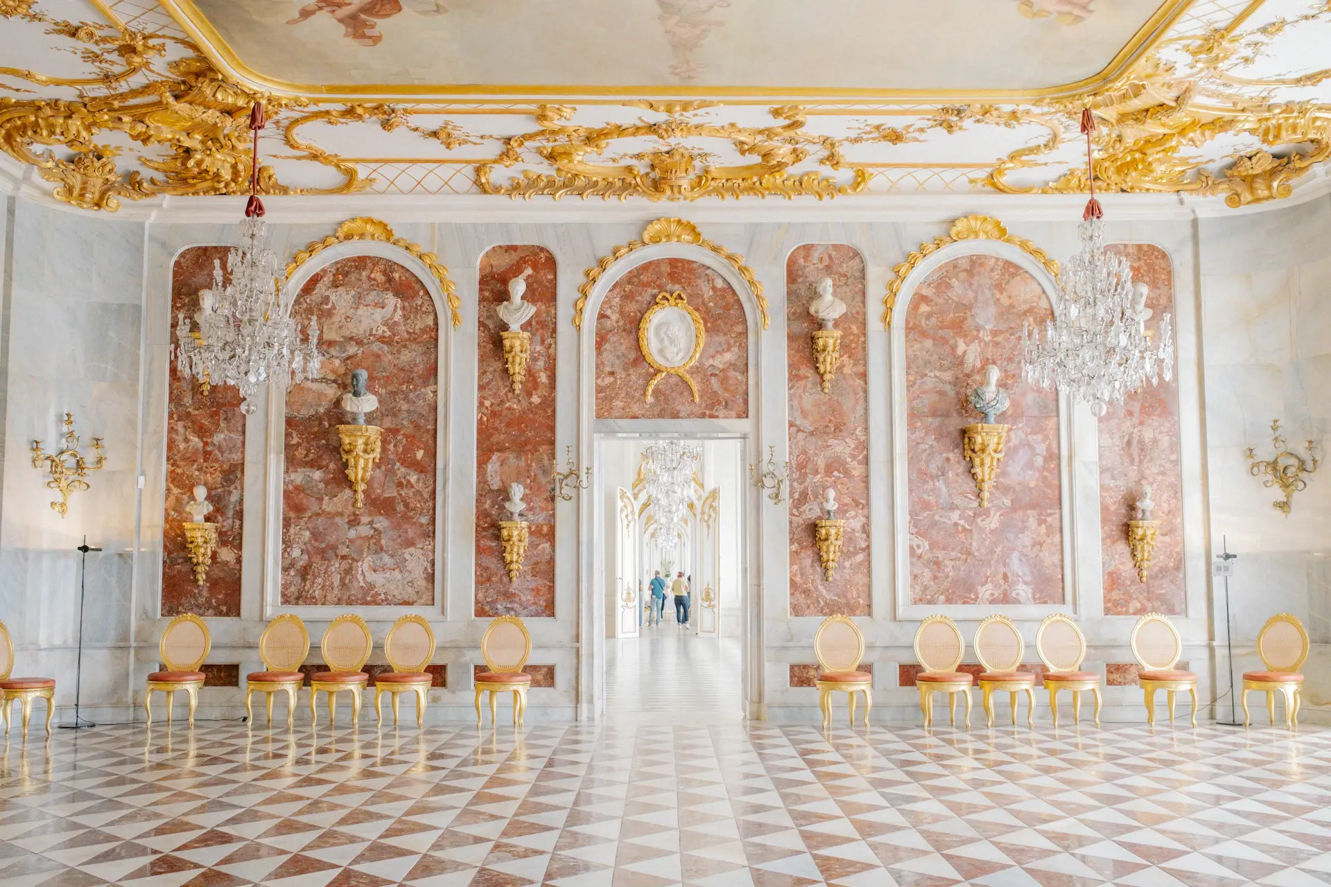 Planner reviewing a wedding layout in a palace ballroom
