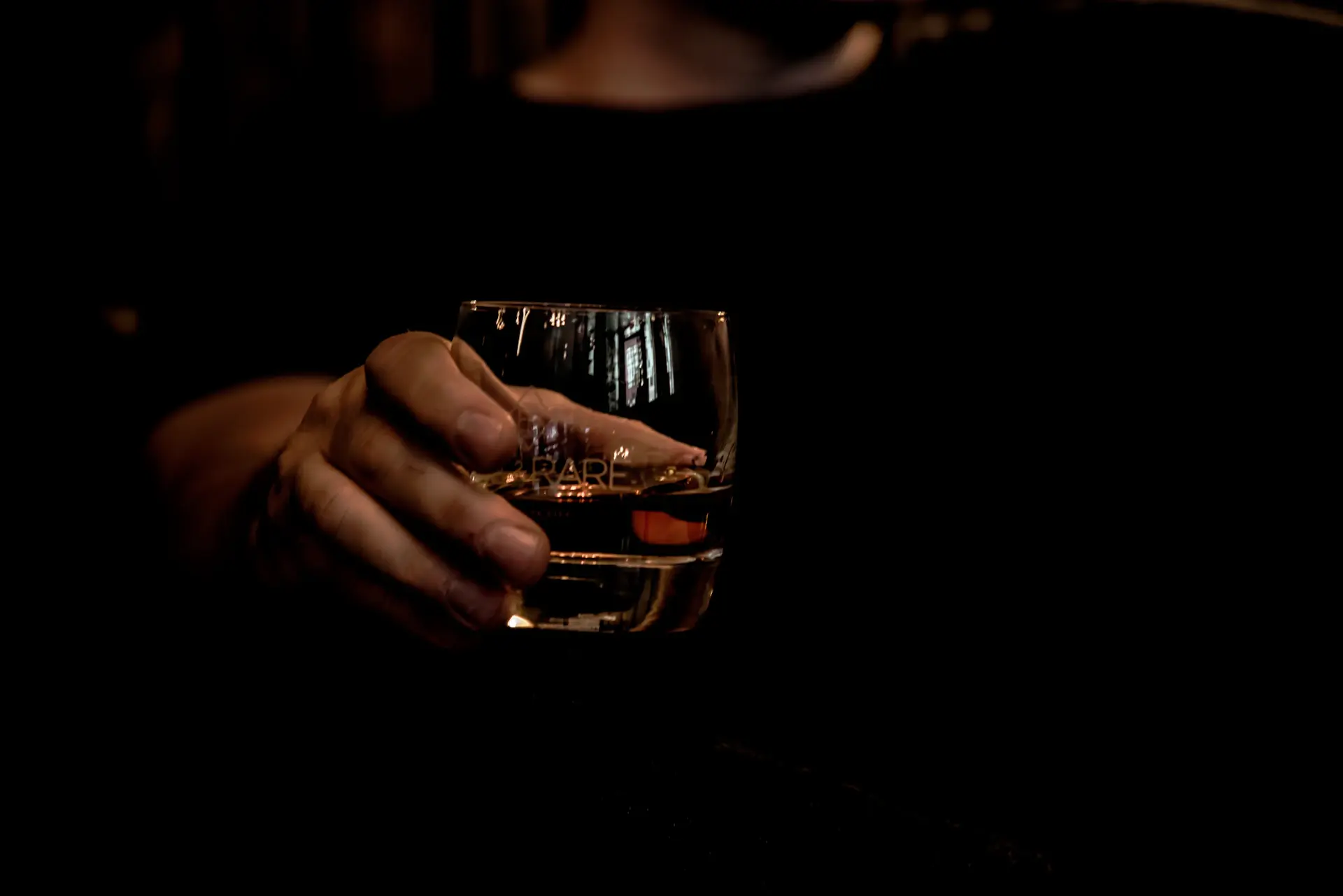 A connoisseur savouring the aroma of a dark spirit