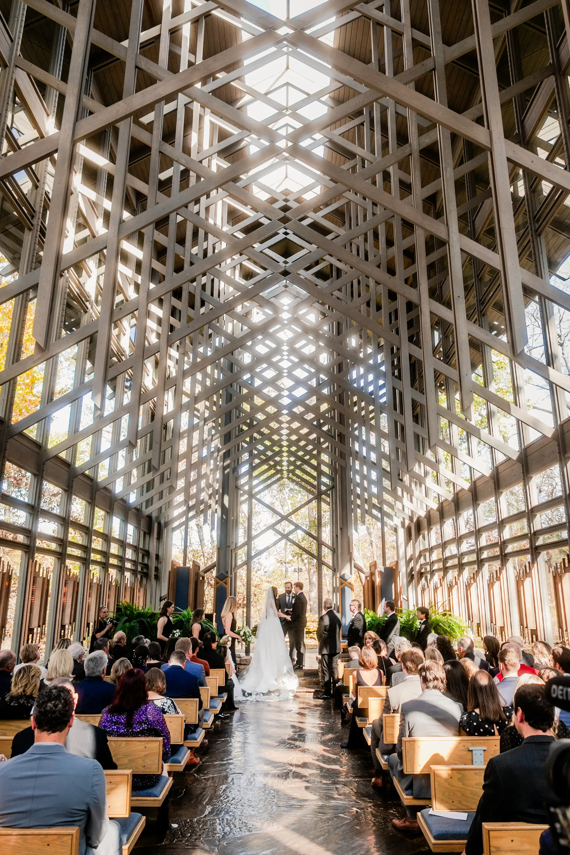 A light-filled chapel hall with arched windows set for an intimate ceremony