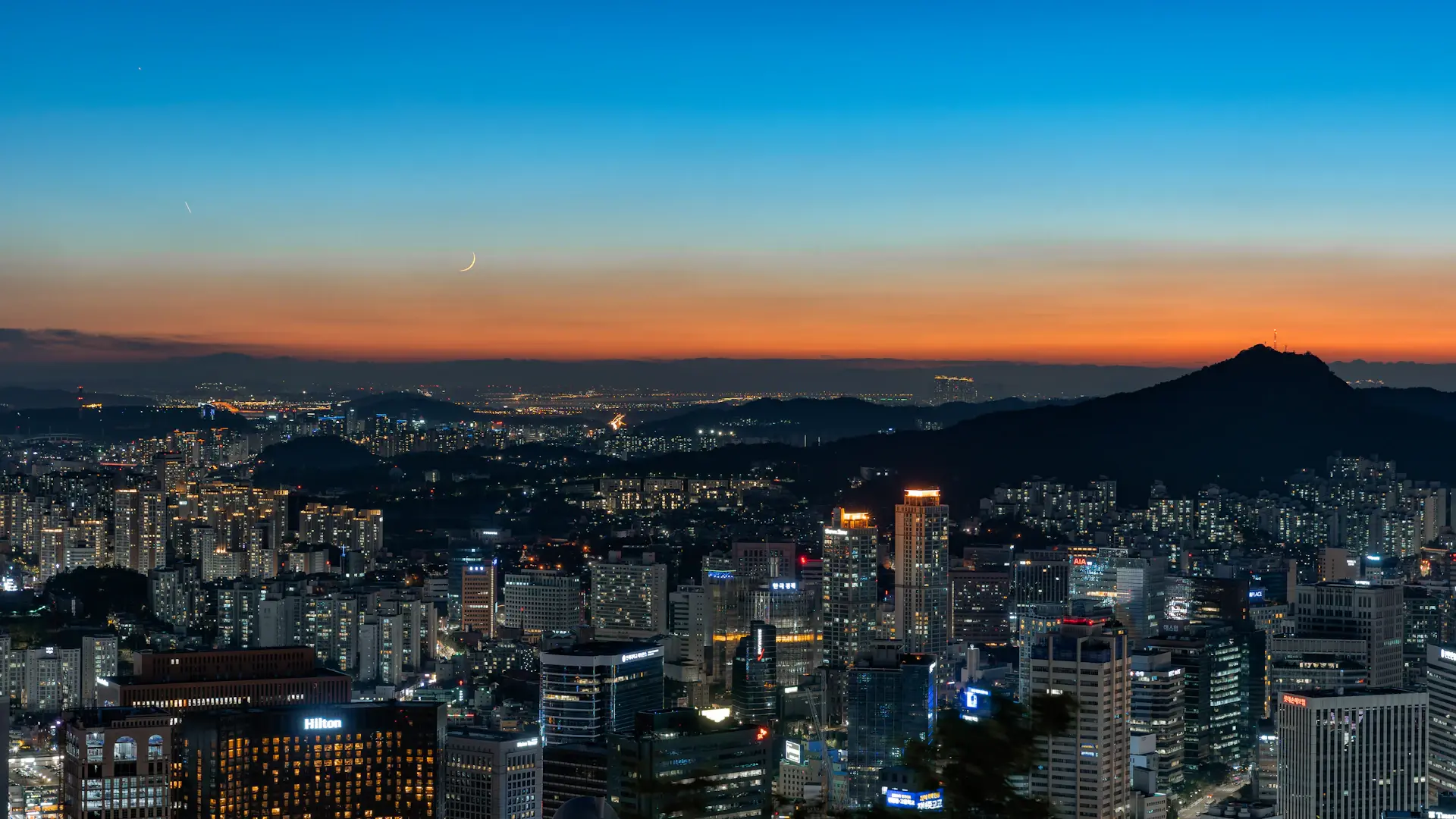 Evening skyline of Seoul with a university campus in the foreground