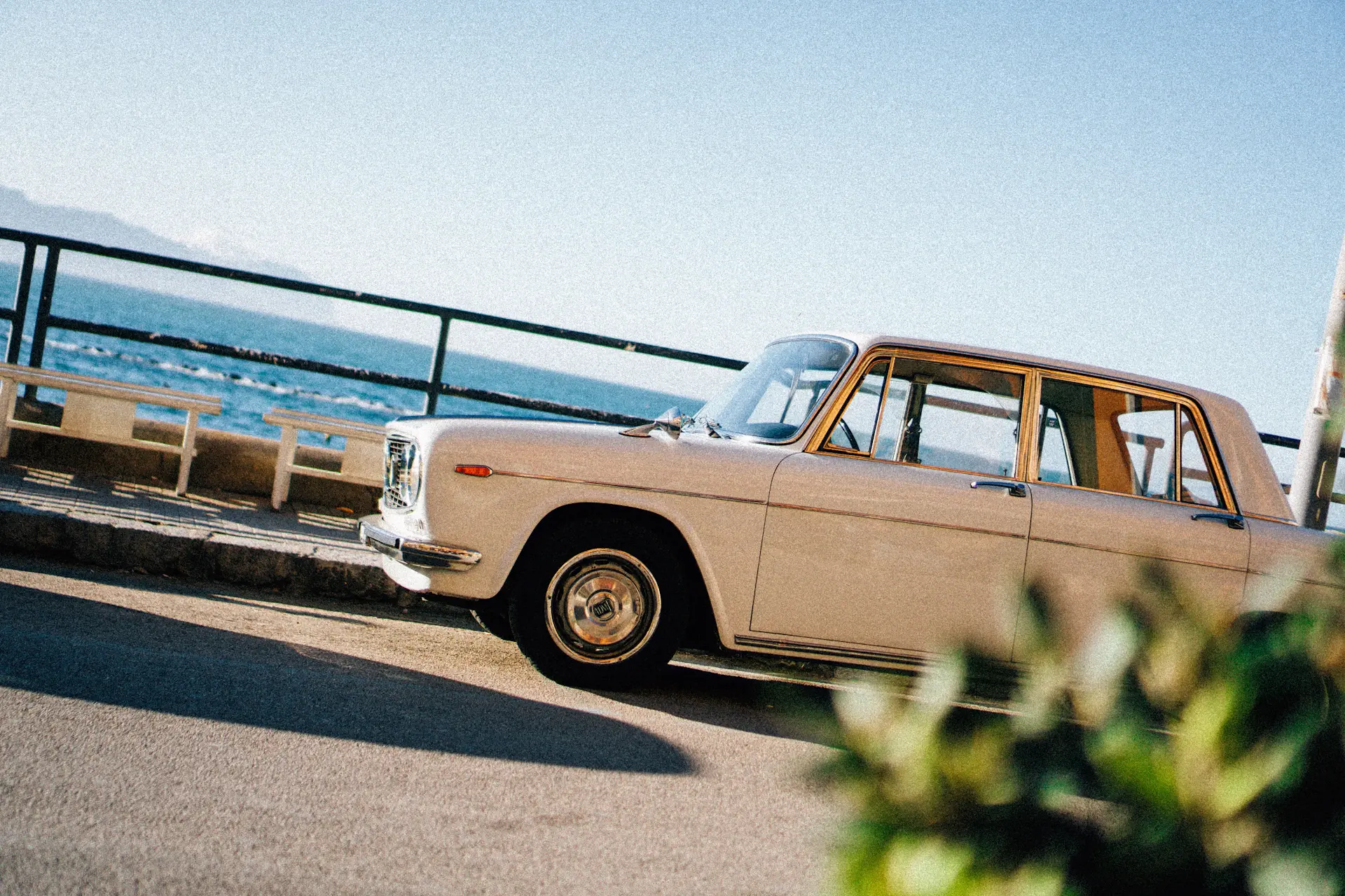 A vintage motorcar on a coastal road