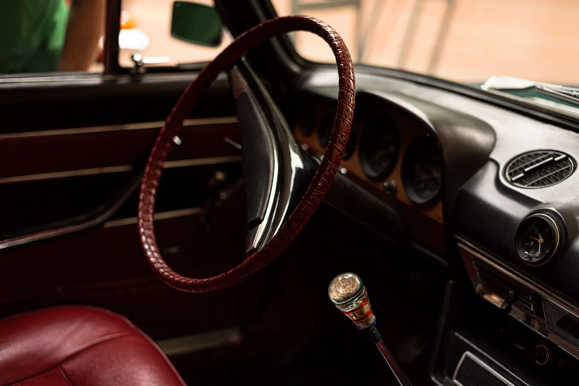 A craftsman fitting bespoke interior detailing in a 1990s atelier