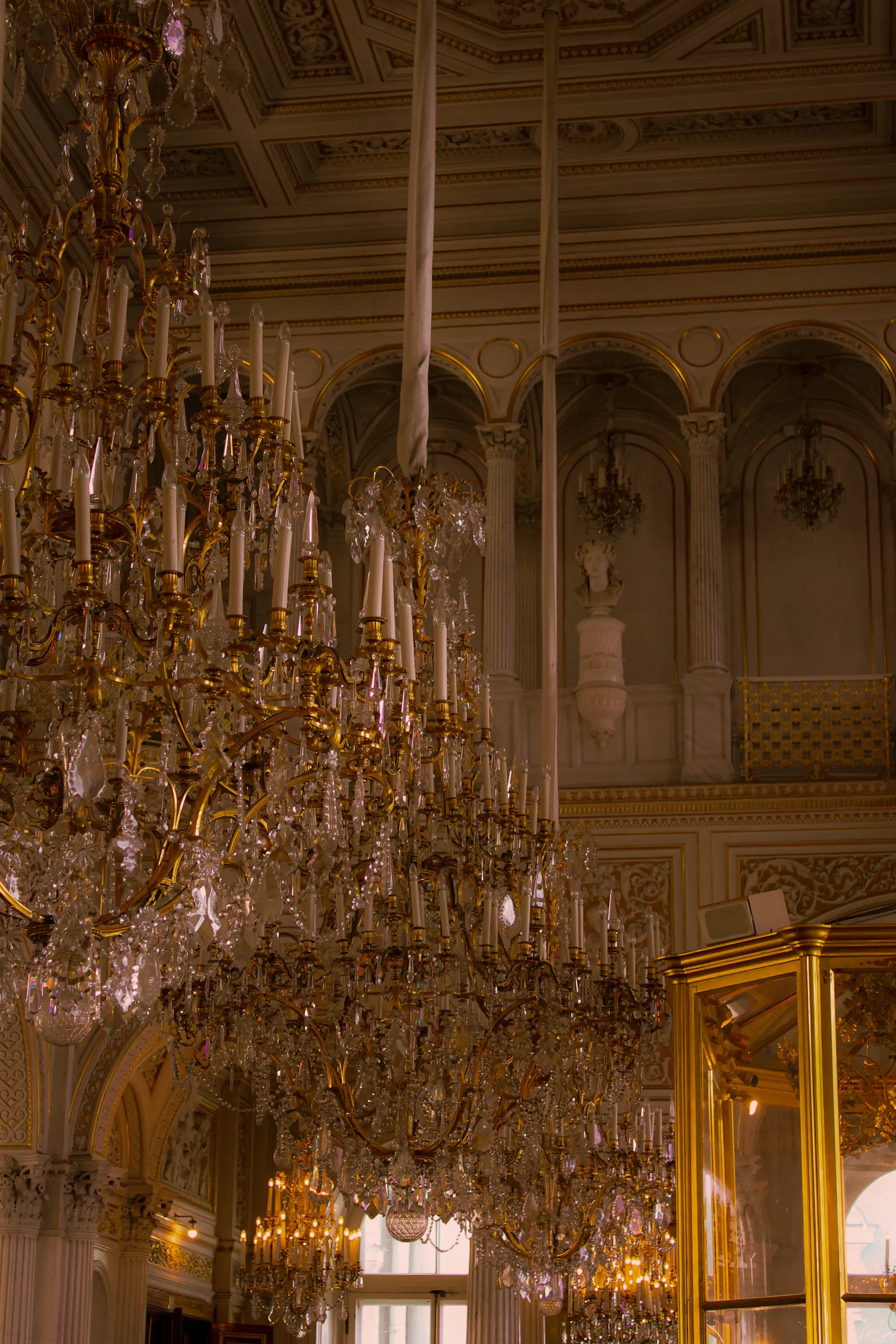 Crystal chandeliers above a palace ballroom