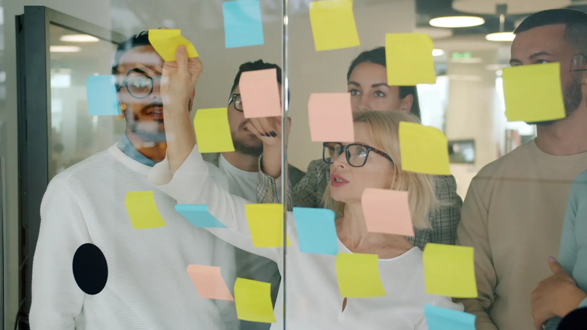 Discovery workshop session with sticky notes and screens