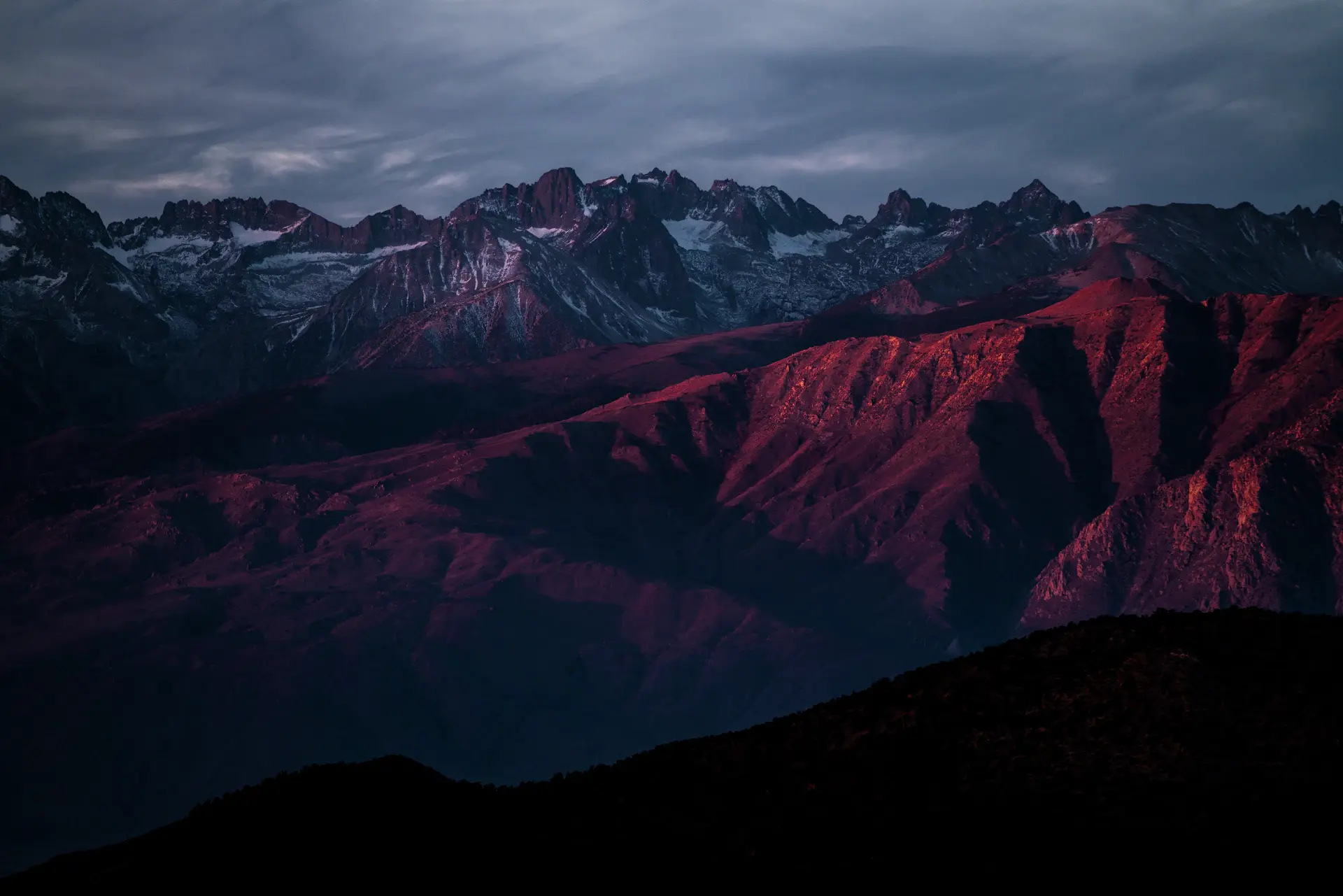 Distant snow peaks under a deep twilight sky