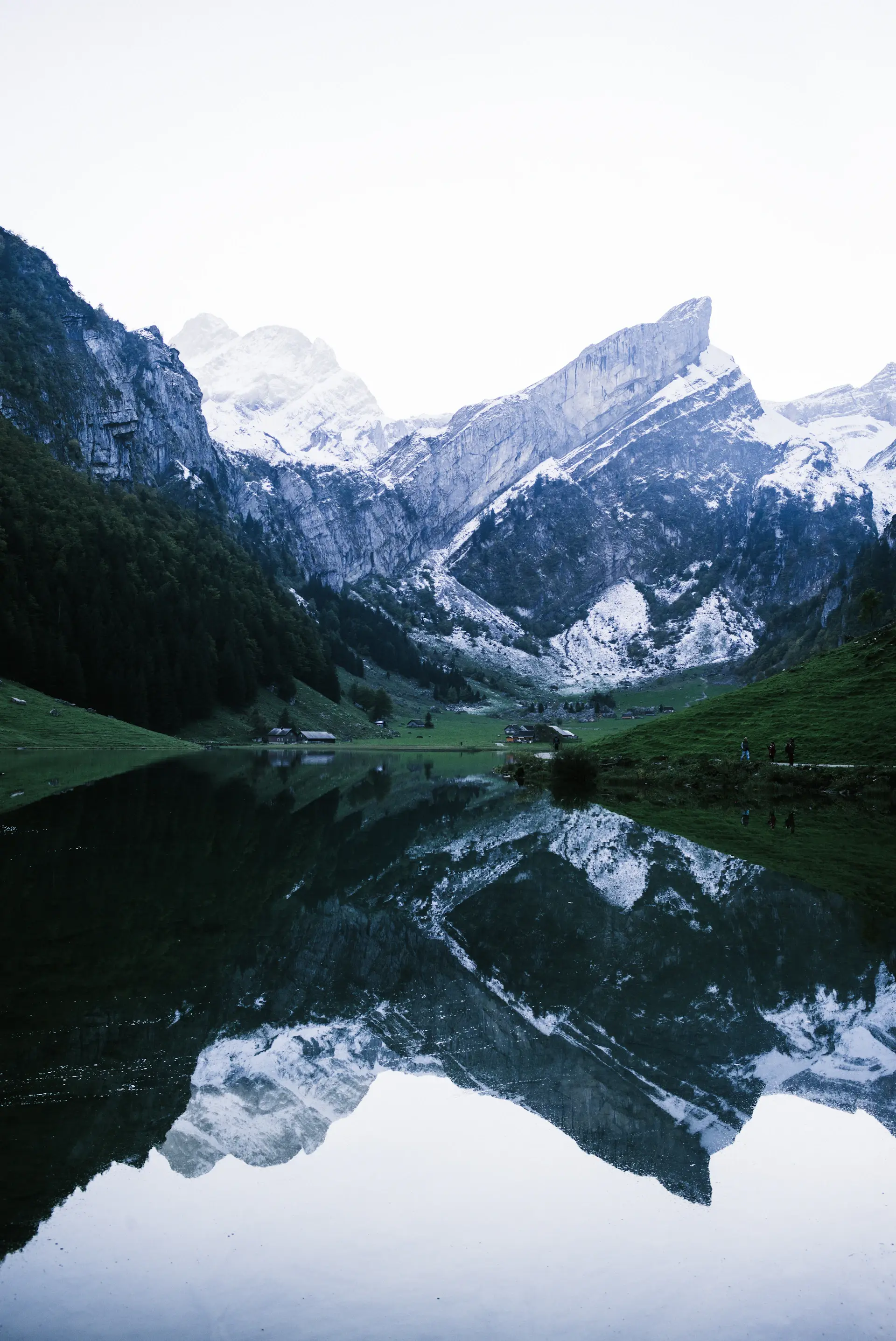 An alpine lake mirroring snow-dusted peaks