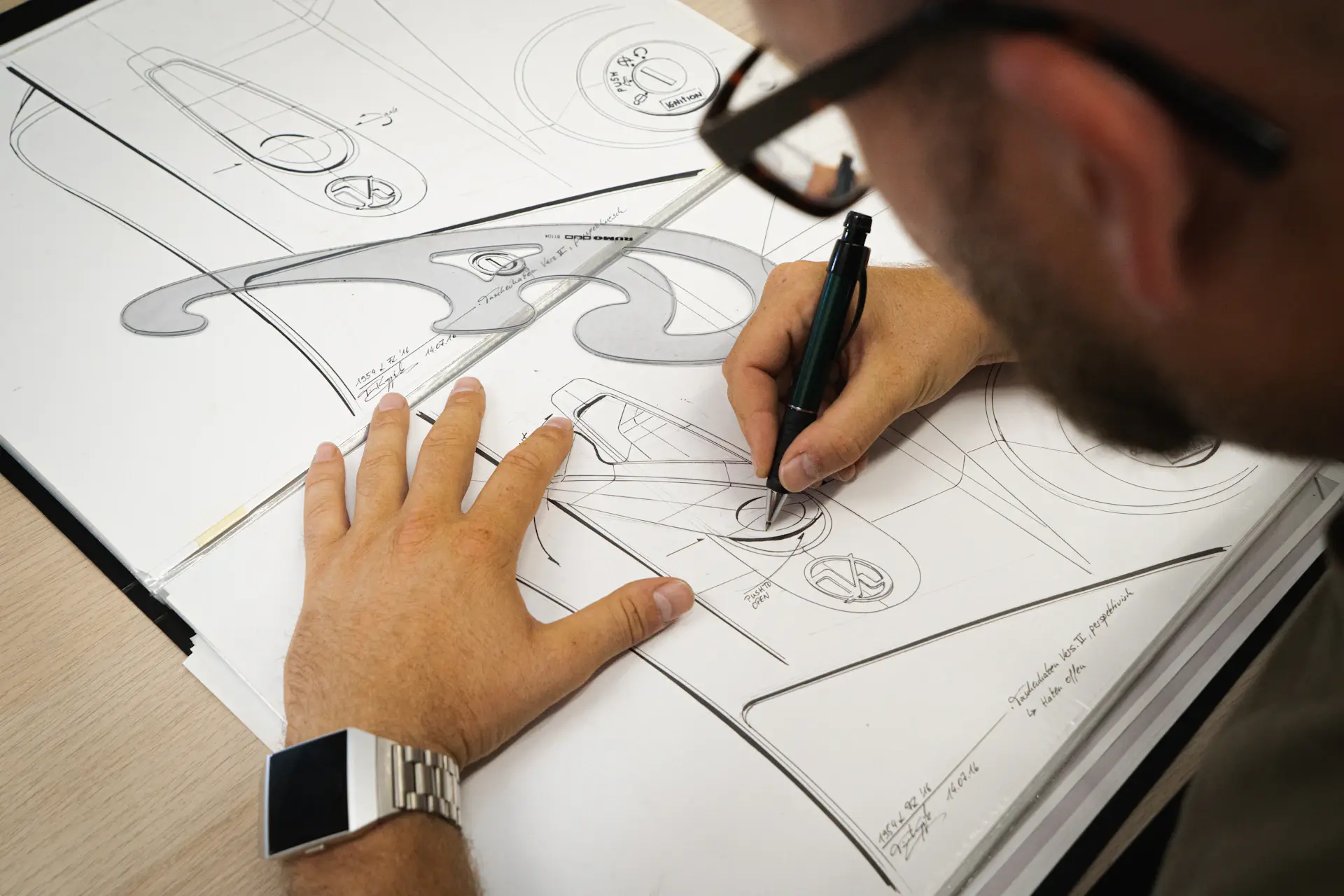 Designer sketching the lines of a luxury coupe