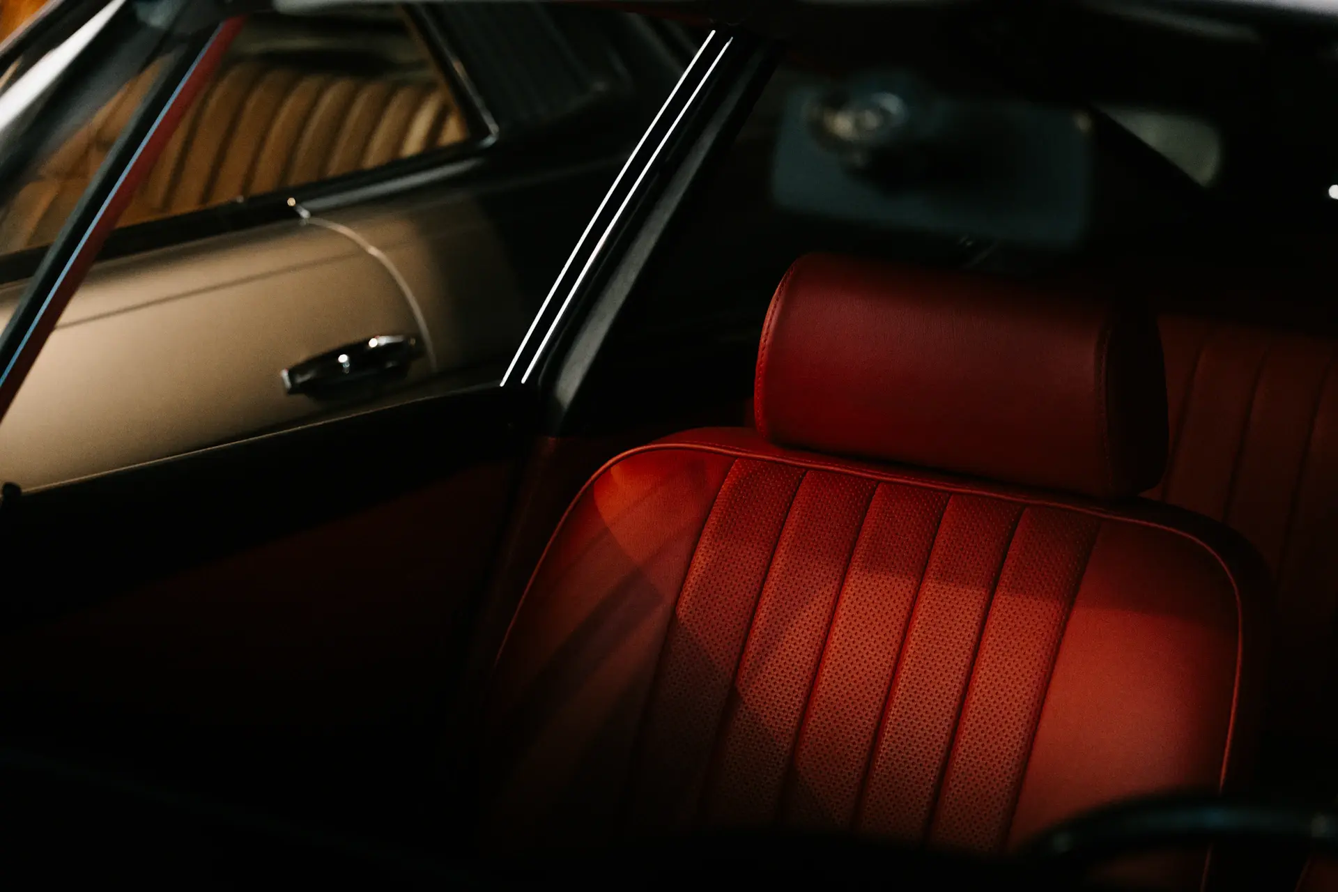 A richly appointed bespoke motorcar interior in deep tones