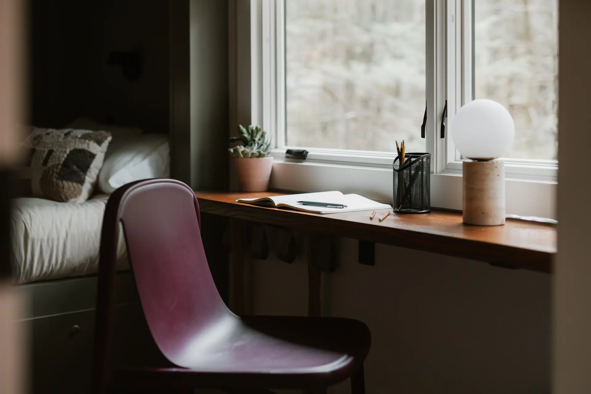 Cozy reading nook with a laptop and warm lamp light