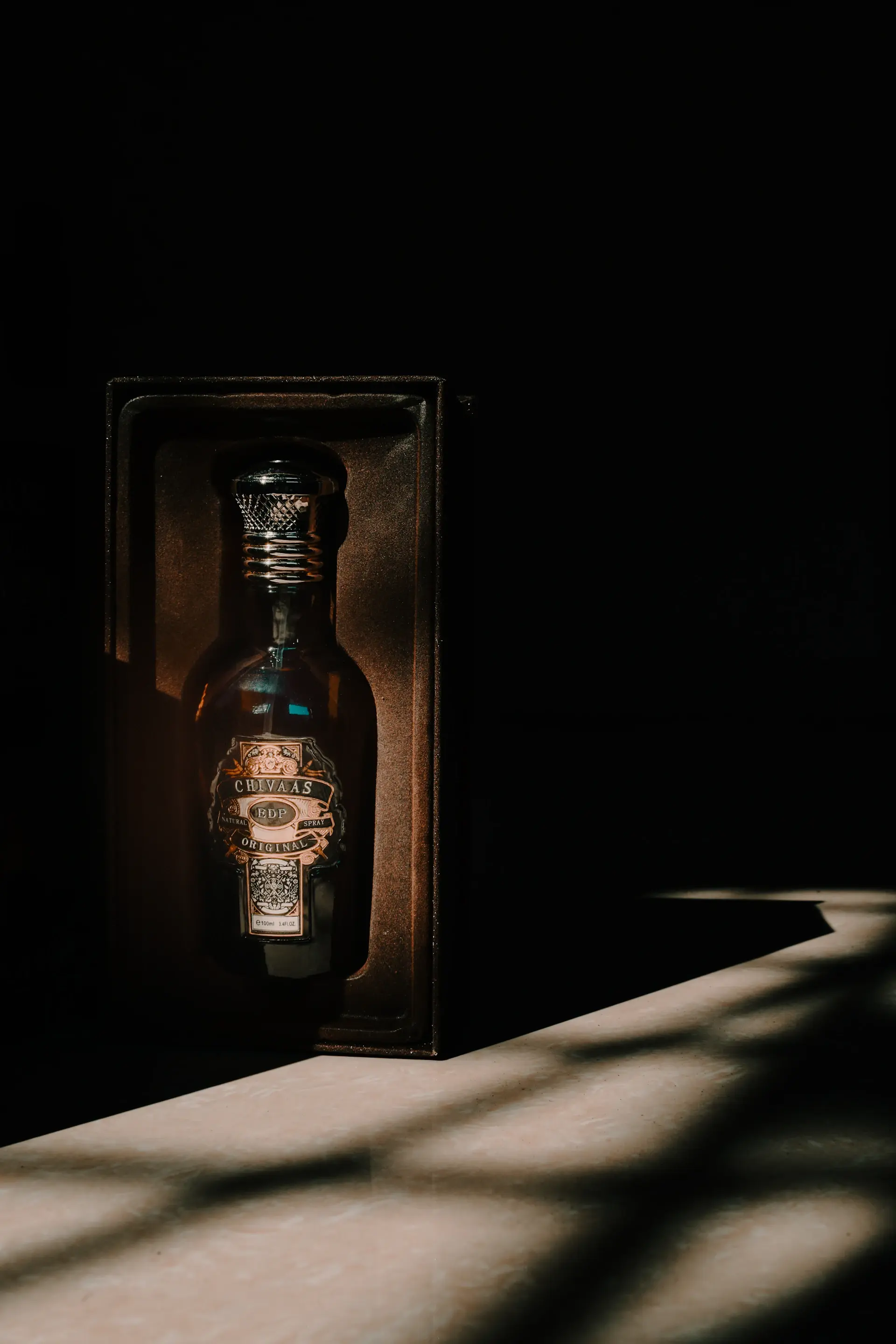 A rare numbered bottle in a velvet-lined presentation case under spotlight