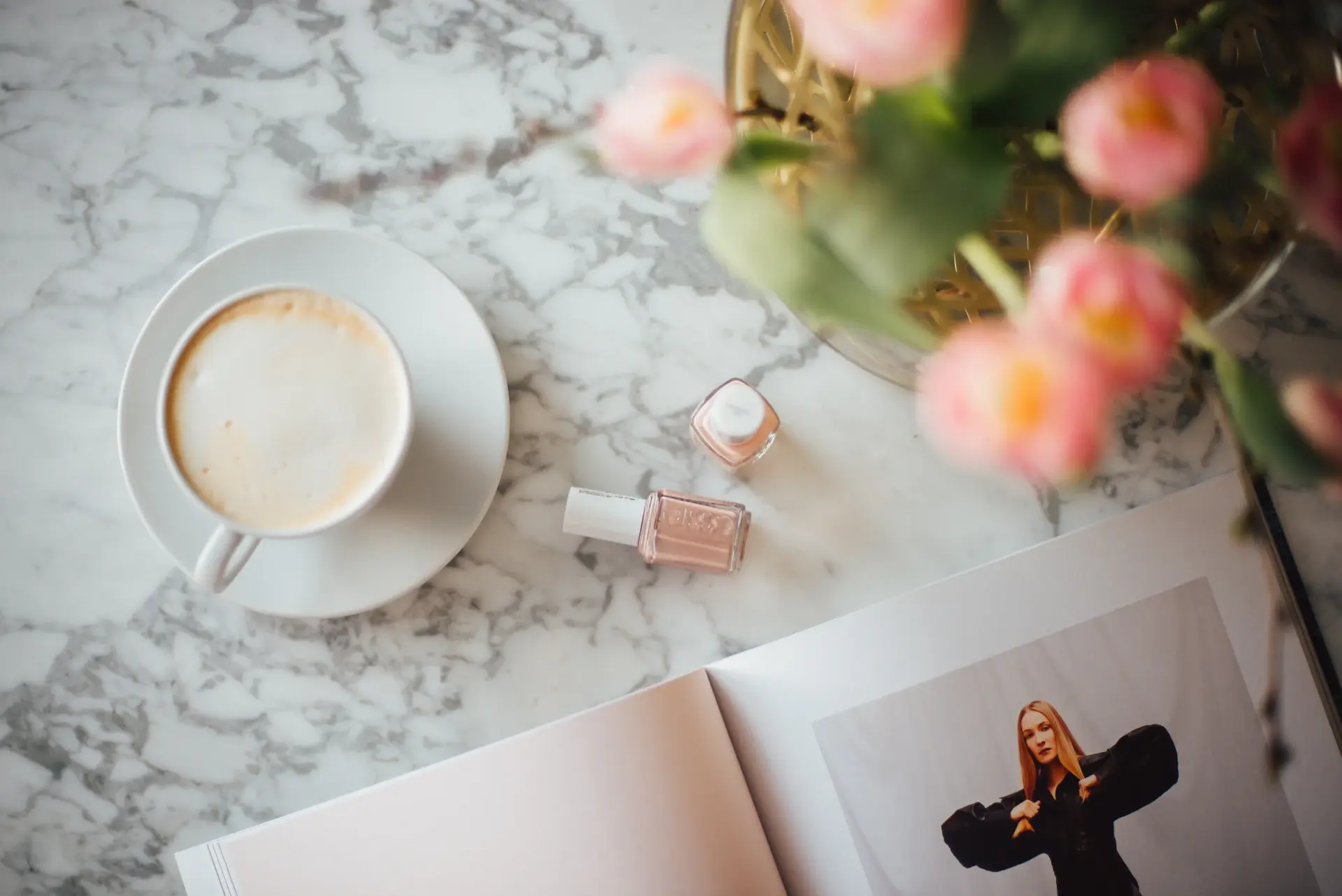 Detail of marble cafe table with espresso and book