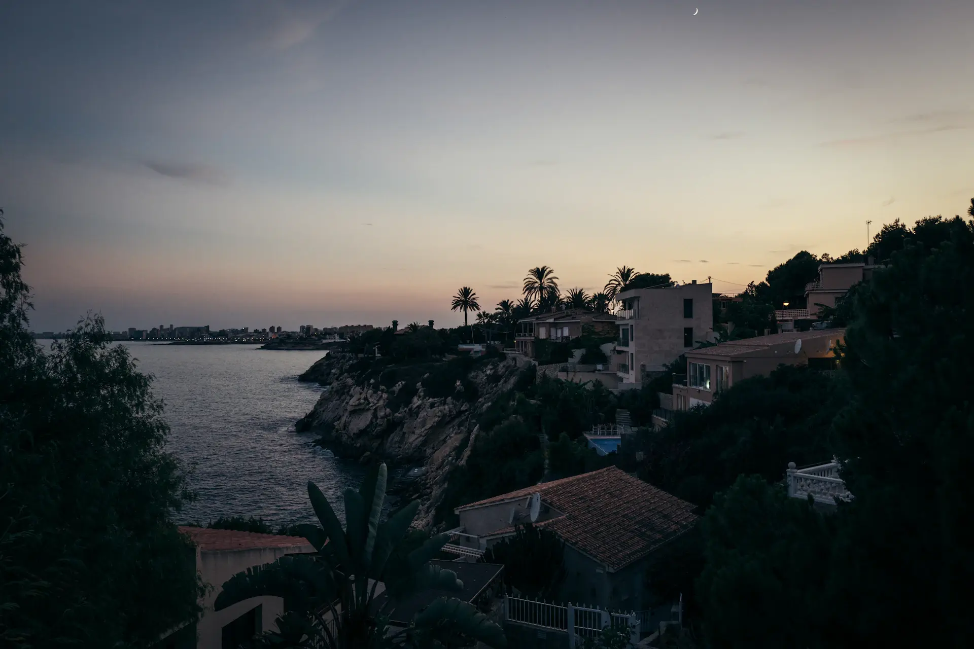 A private villa with infinity pool overlooking the coast at dusk