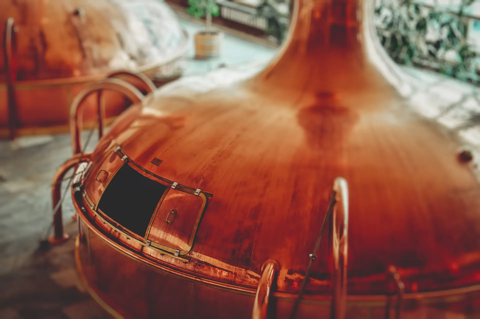 A gleaming restored copper pot still in a heritage distillery