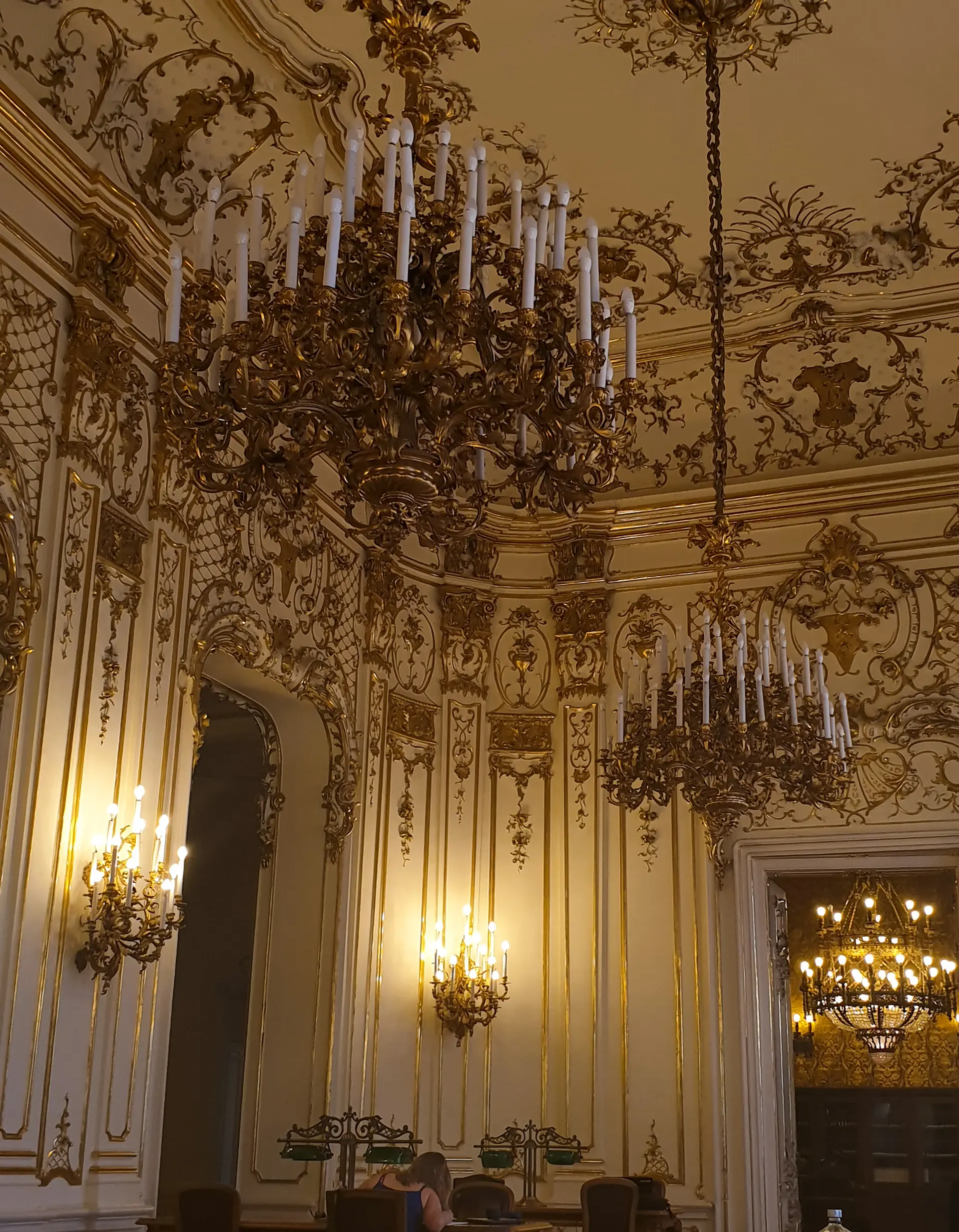 A grand chandelier-lit palace ballroom