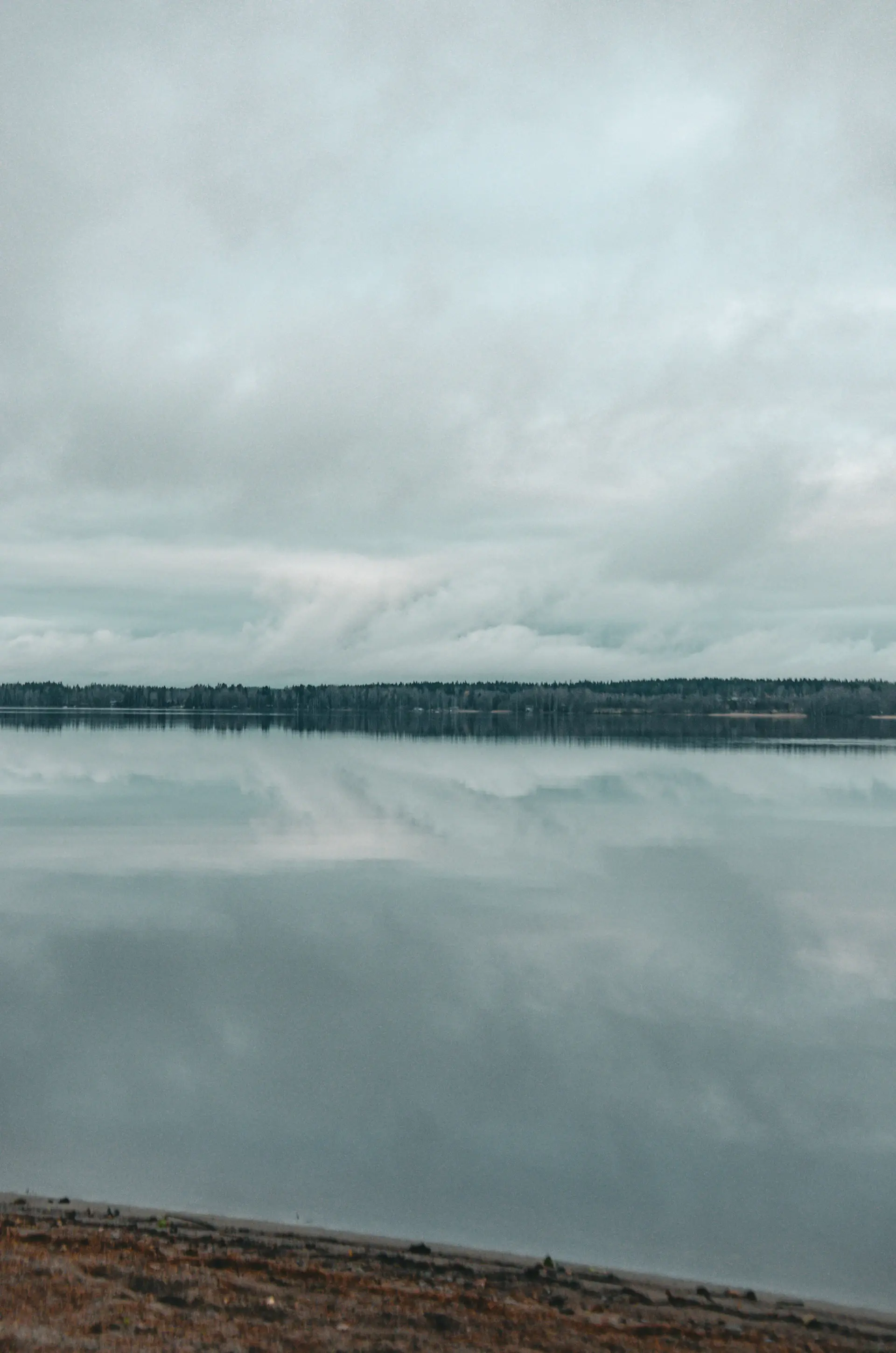 Dramatic storm clouds mirrored on a perfectly calm lake