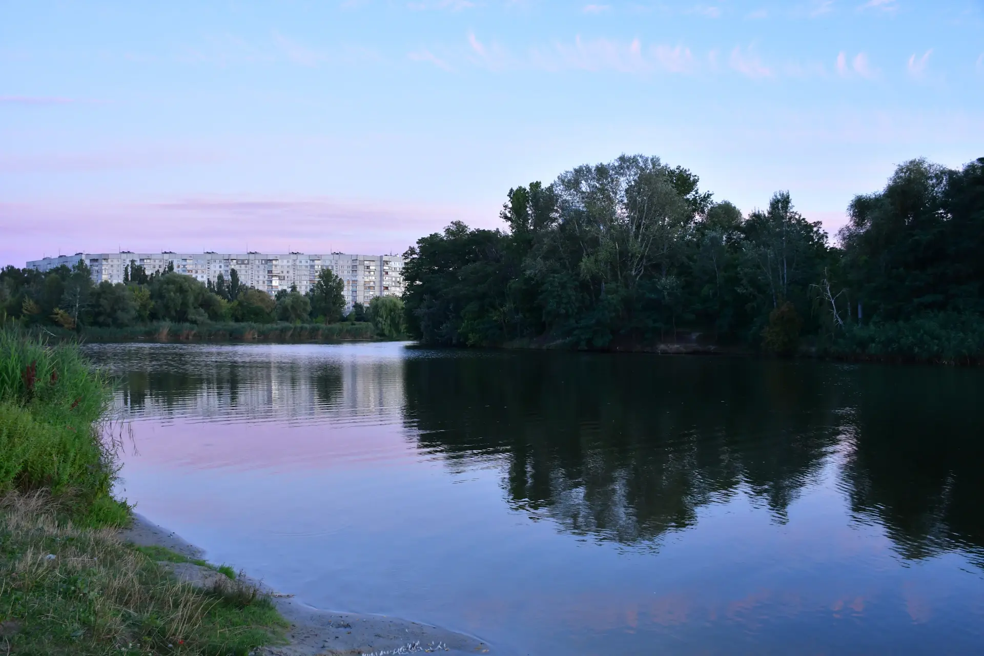 A prime estate at dusk, seen across still water