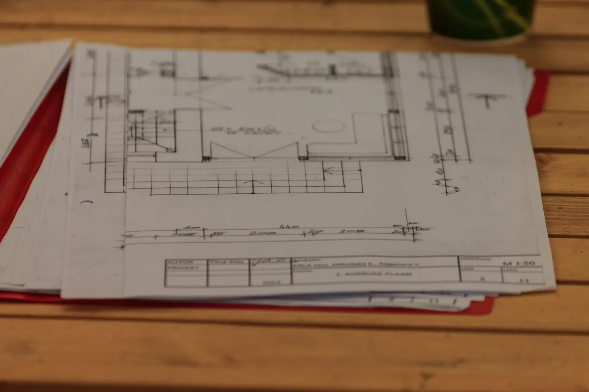 A key resting on an architectural plan atop a stone desk