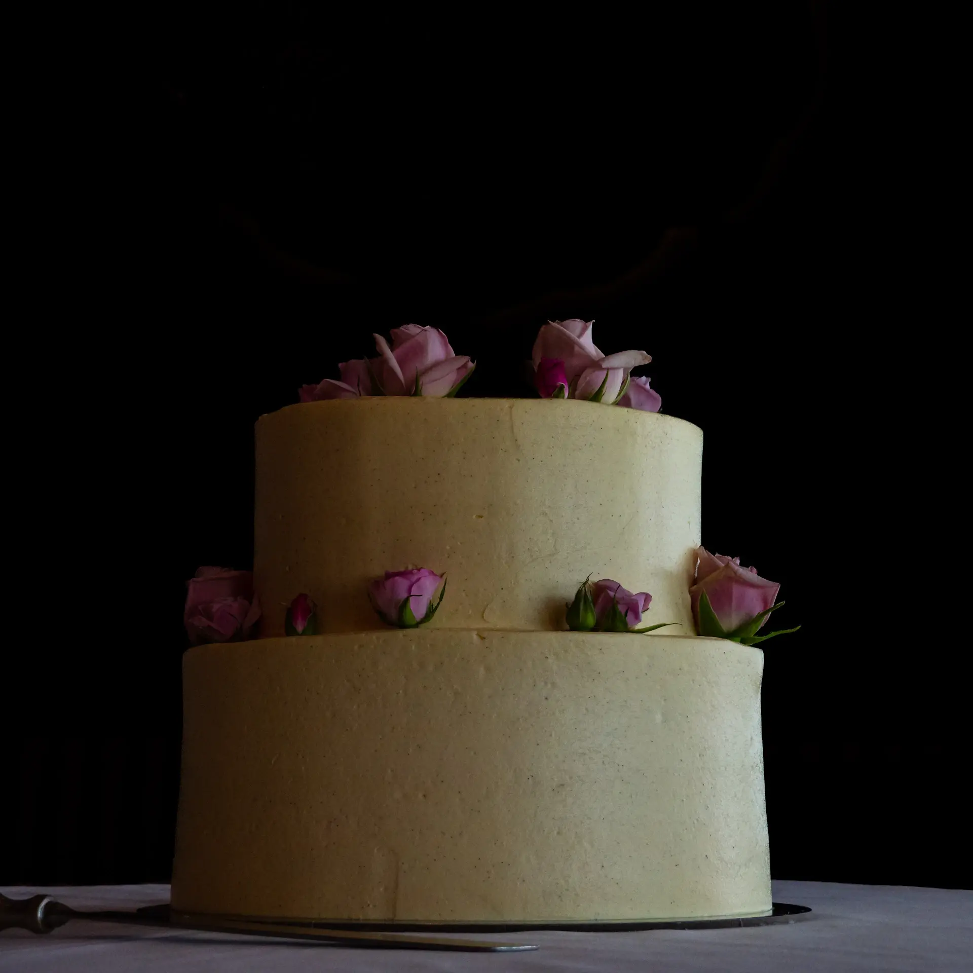 Tiered wedding cake adorned with gold leaf