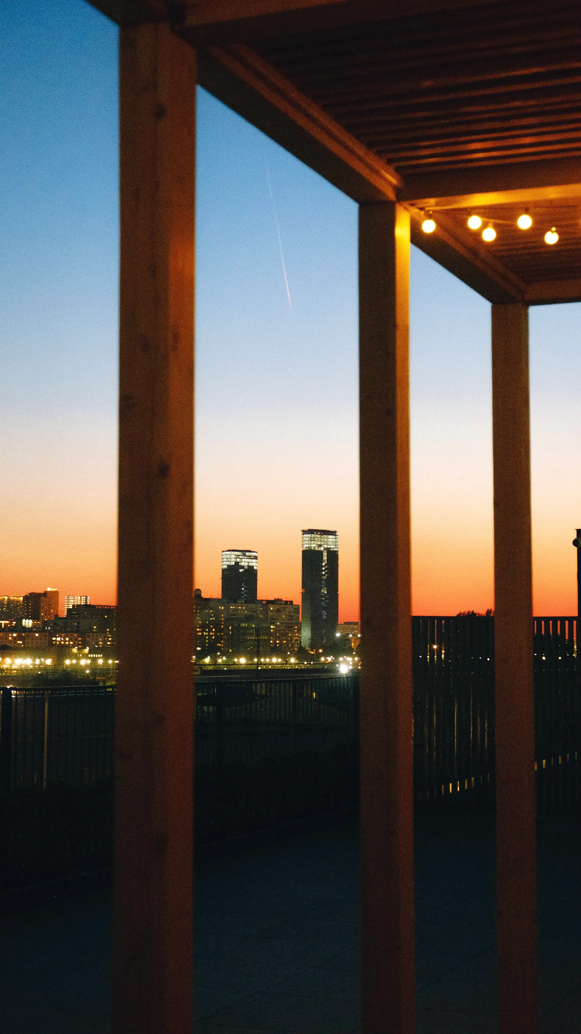 Rooftop pavilion with skyline views at sunset