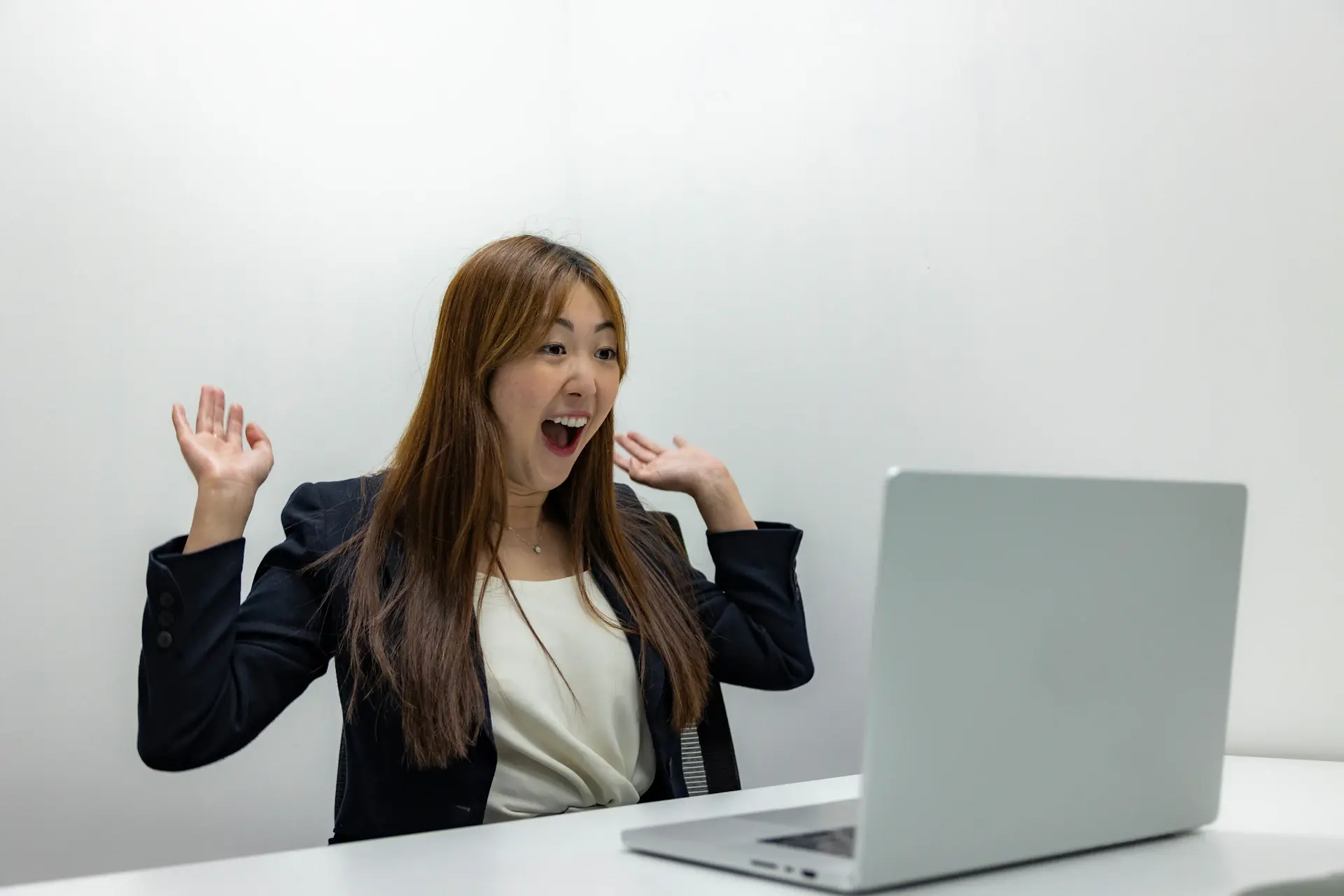 Joyful student reaction in front of a laptop