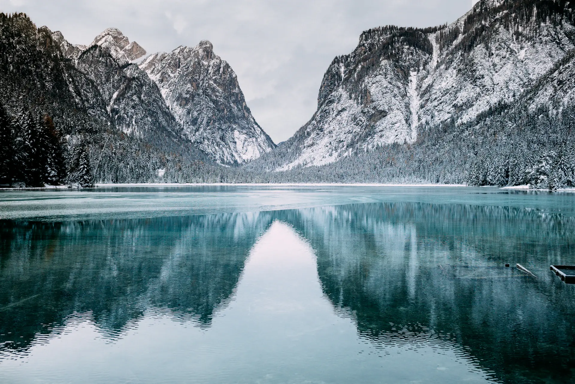 Frozen lake holding a flat, colourless winter light