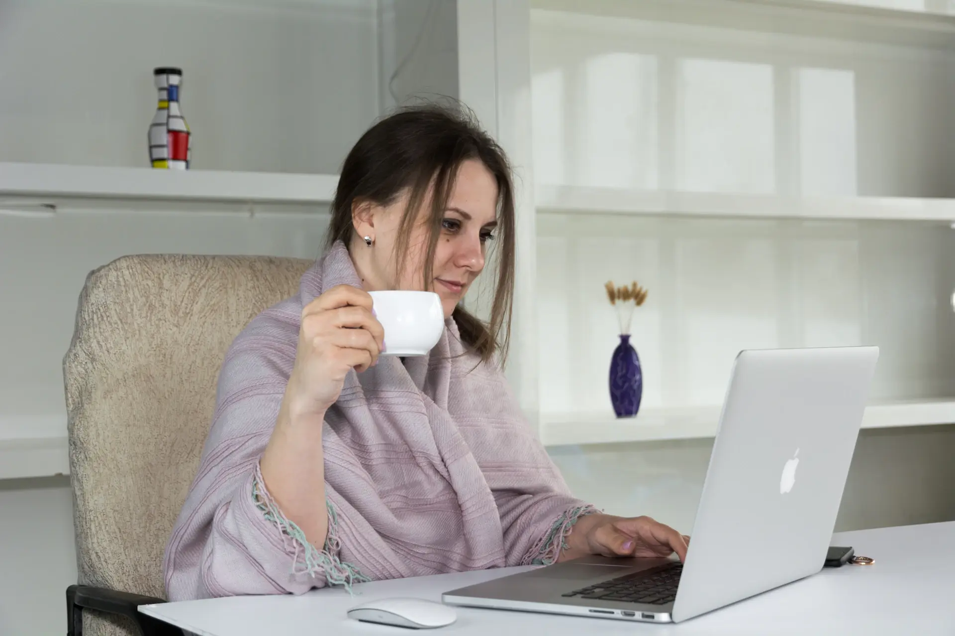 Student organizing application documents and a laptop at an elegant desk