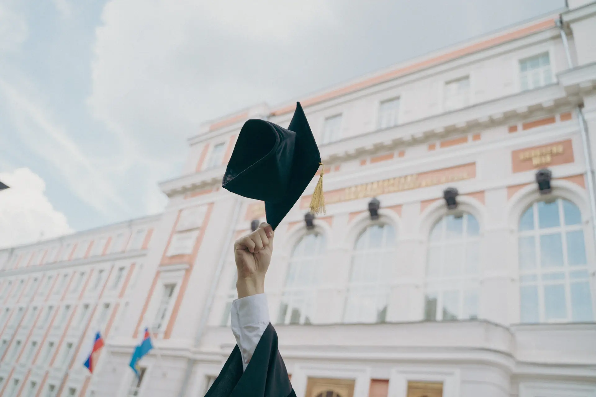 Graduate in cap and gown holding a diploma