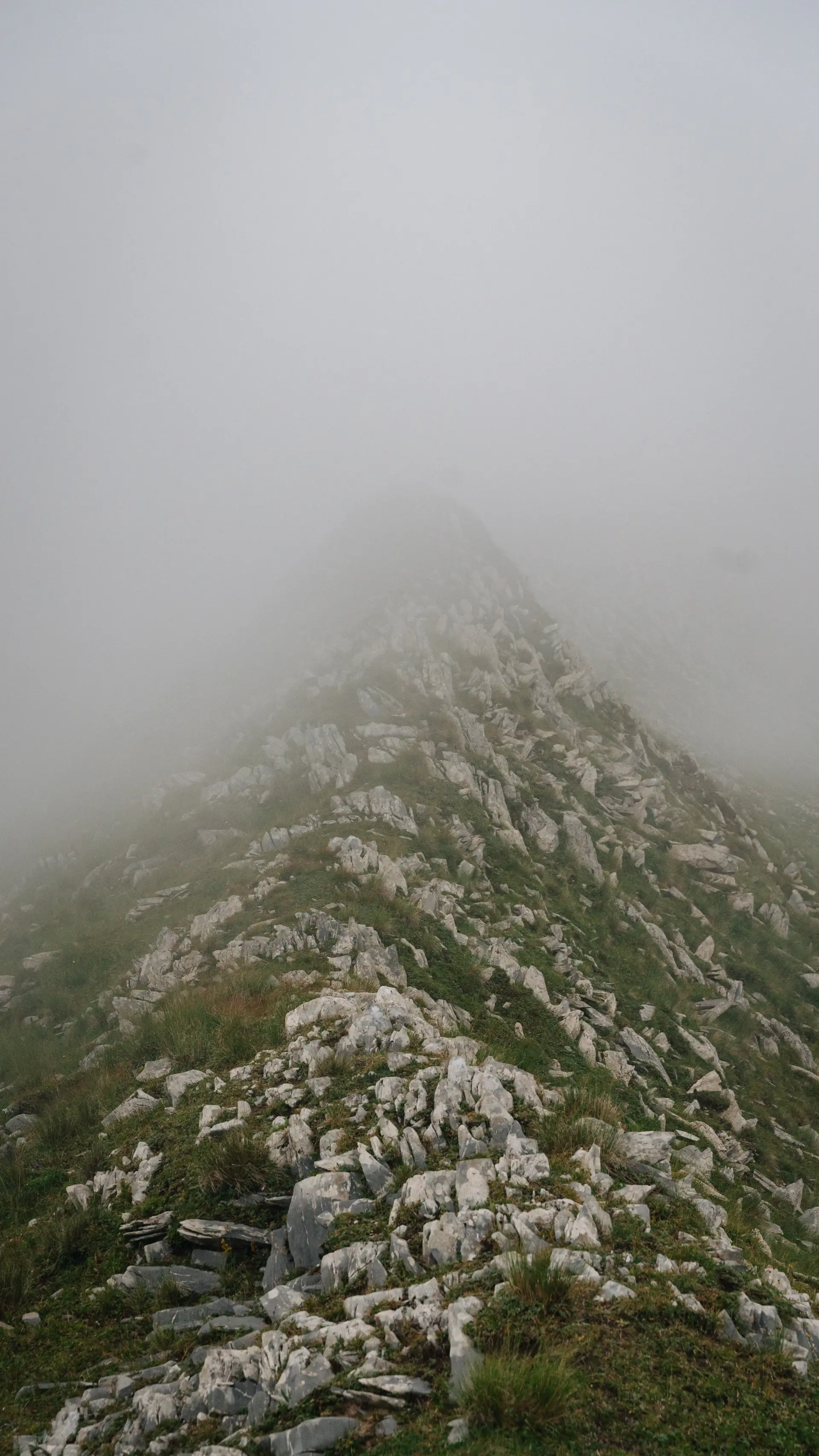 Low cloud drifting over a high rocky ridge