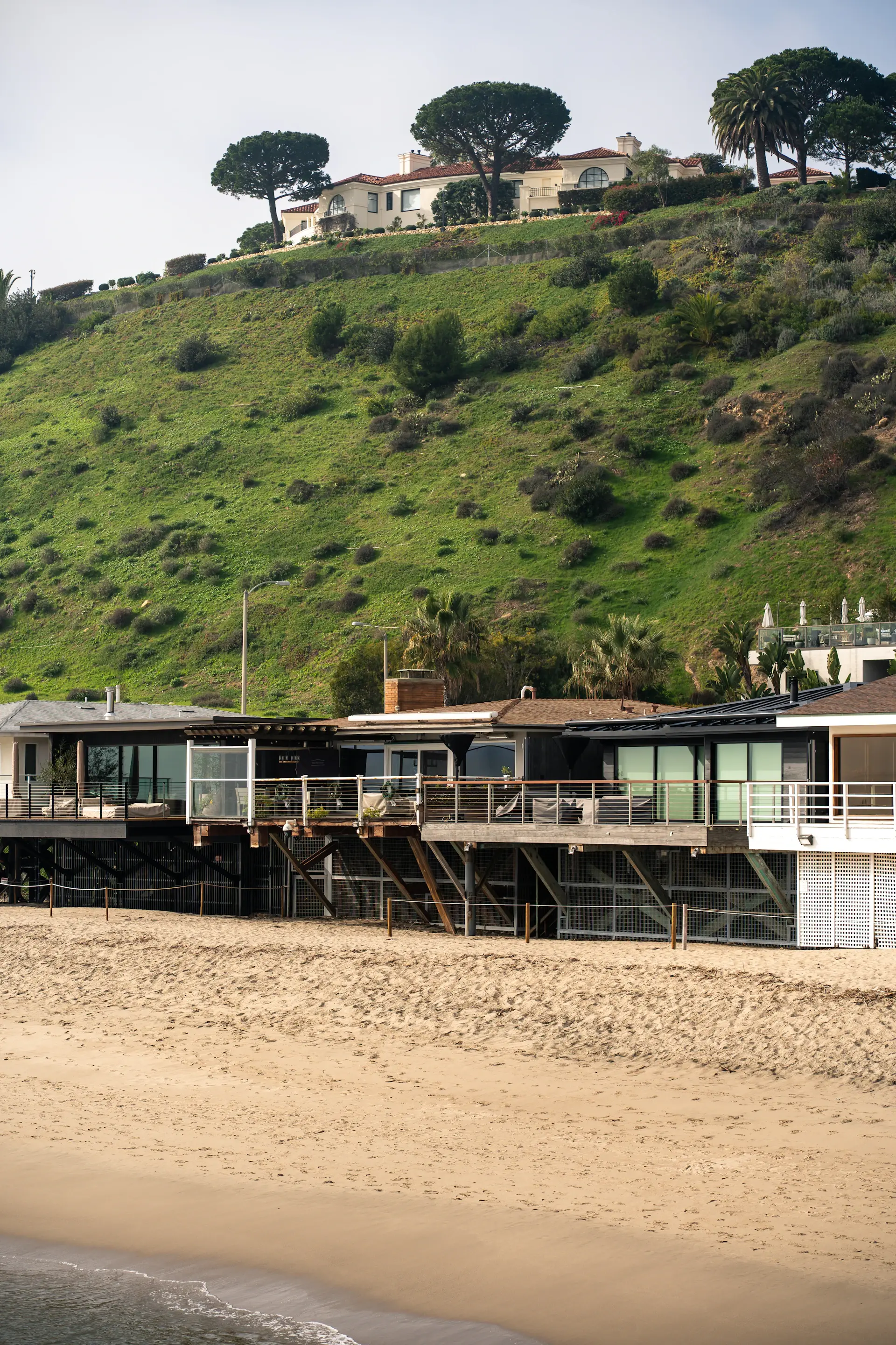 Beachfront house with glass walls facing the ocean