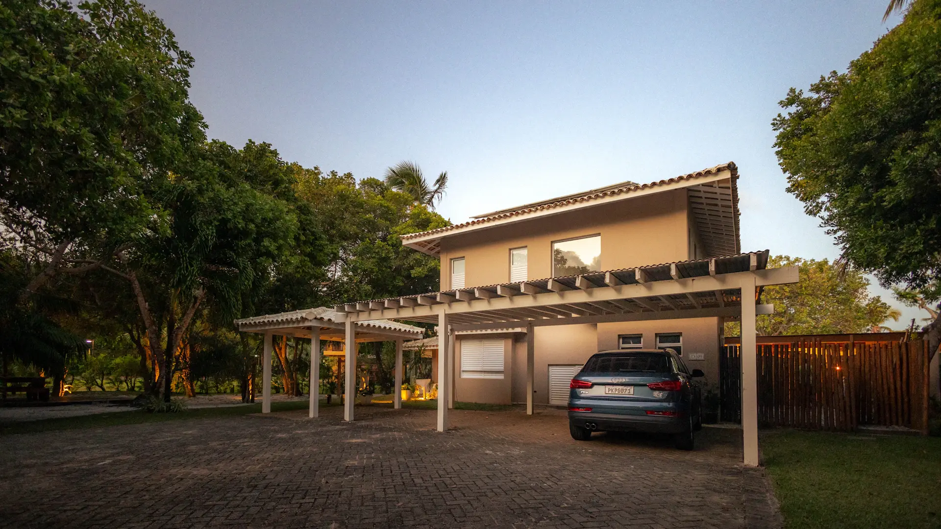 A Prestige motorcar at rest within a private estate at dusk