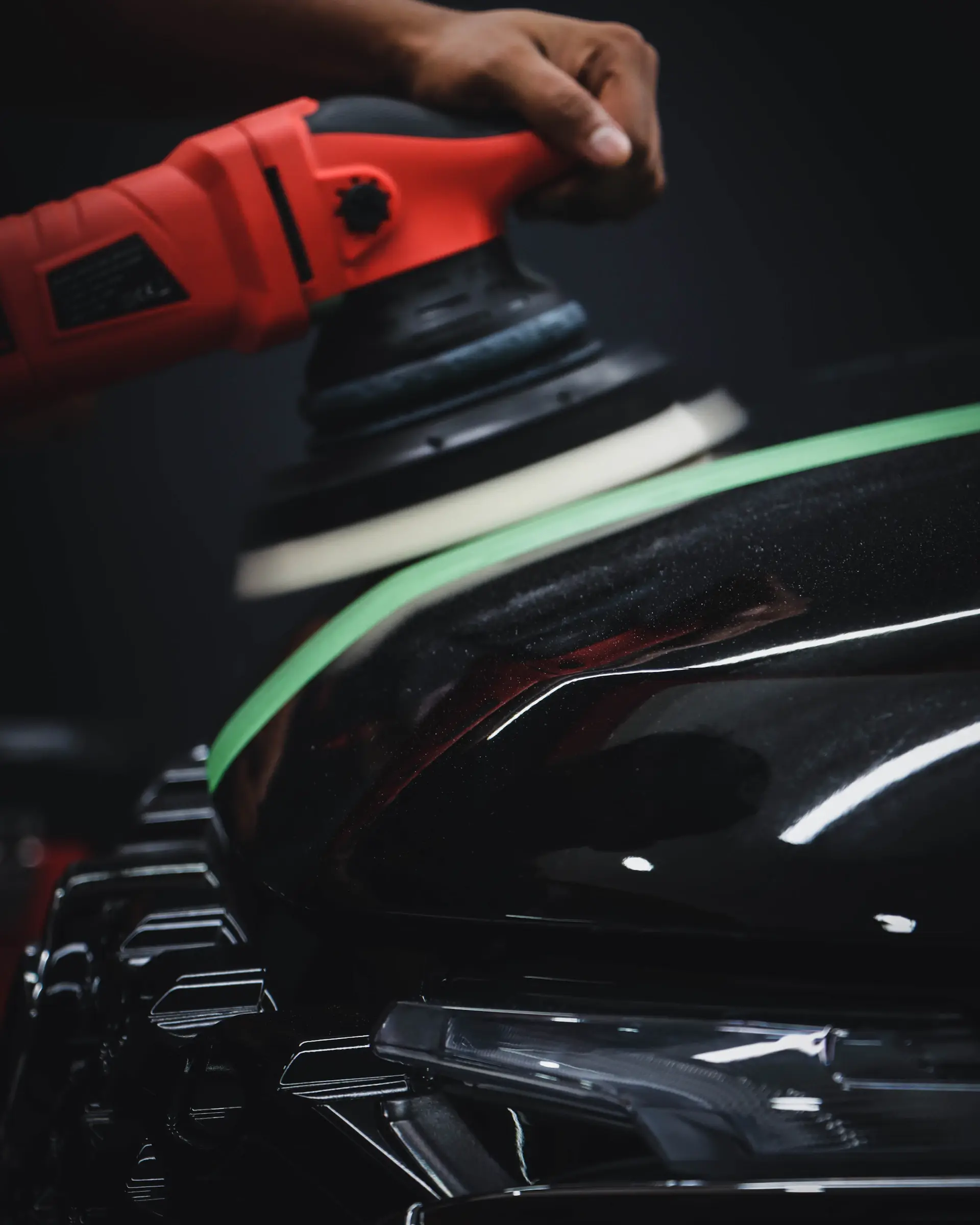 Hand polishing the deep paint finish of a luxury motorcar