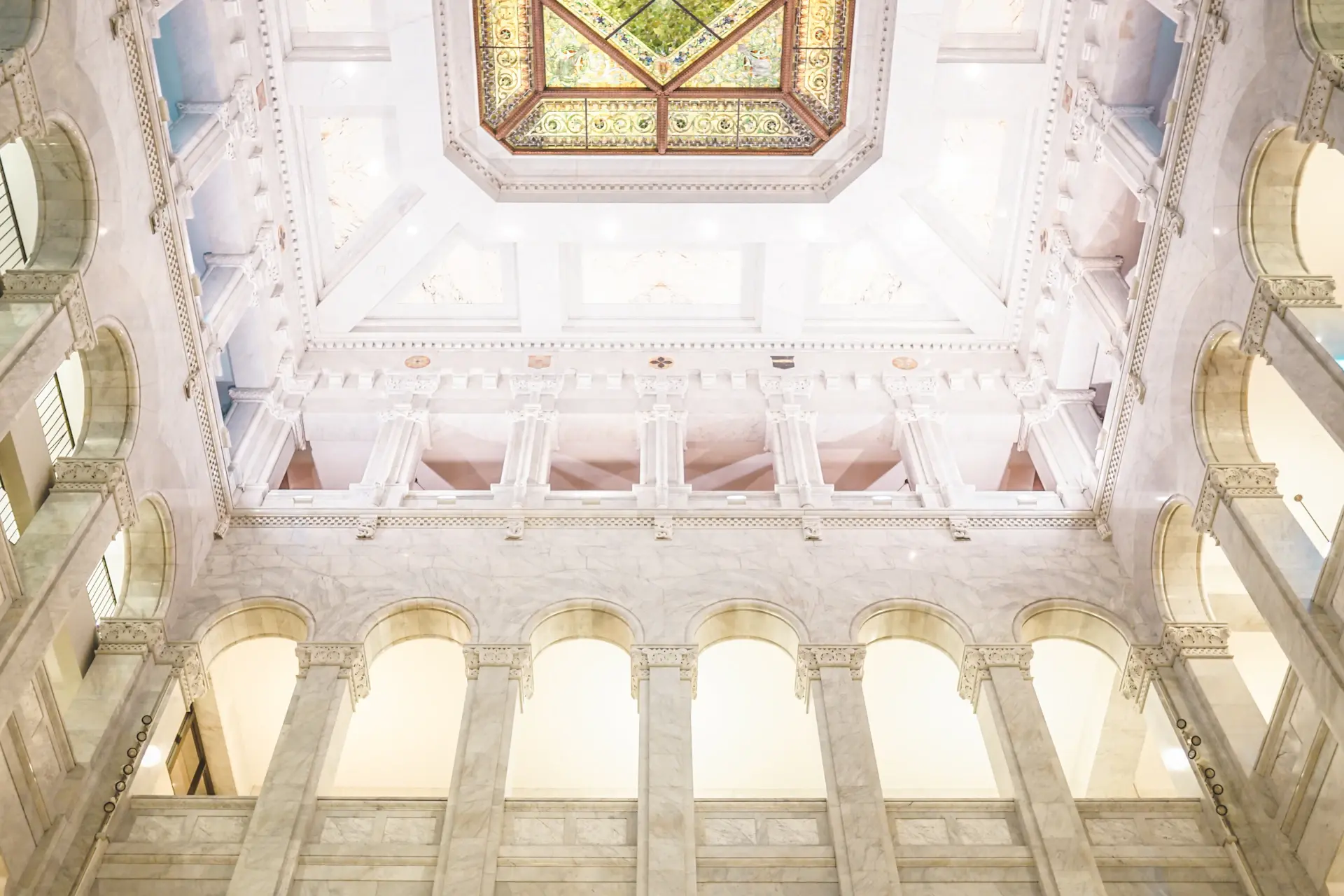 The Marble Atrium with a glass dome and pale stone floors