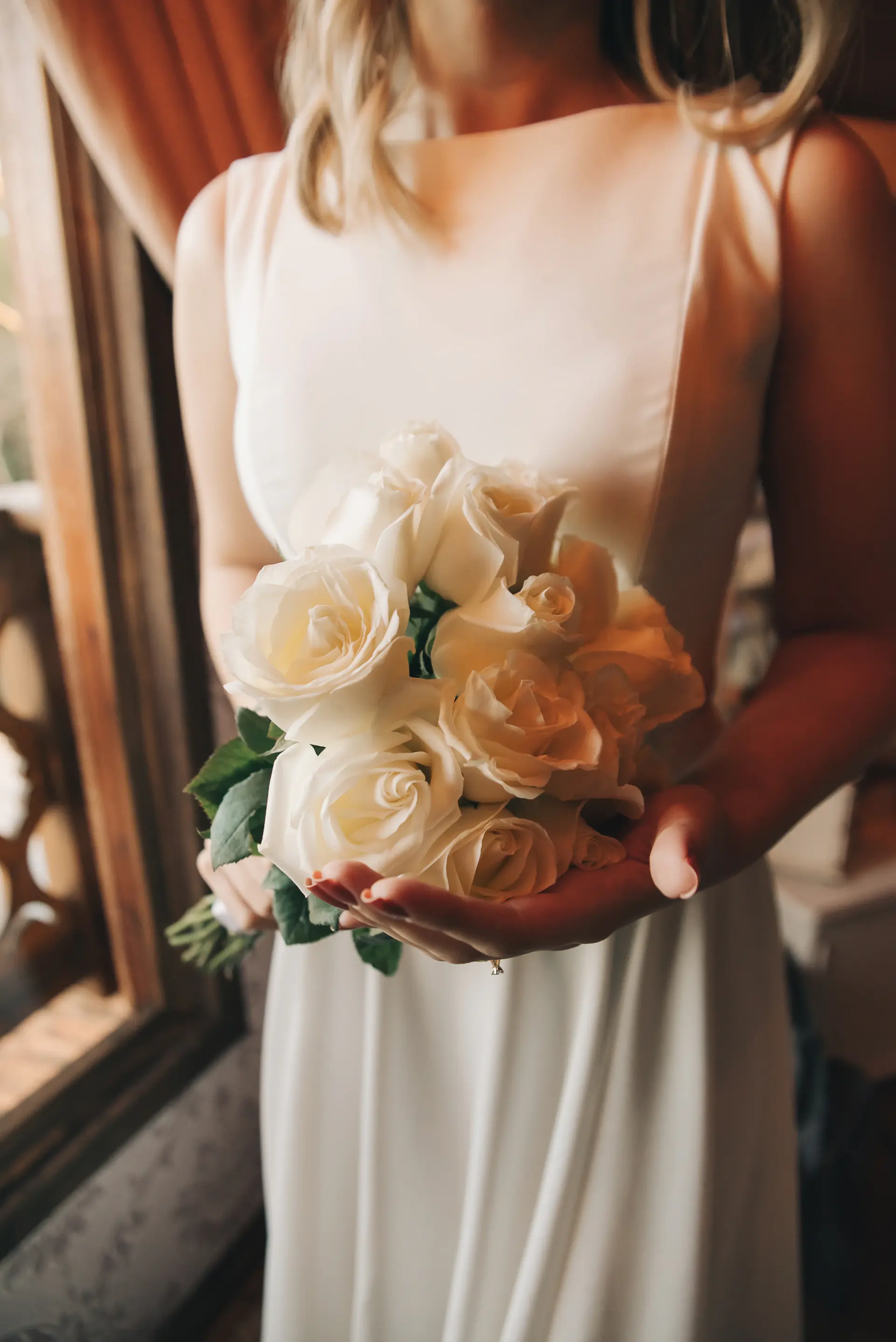 Wide cinematic view of a rose installation at a reception