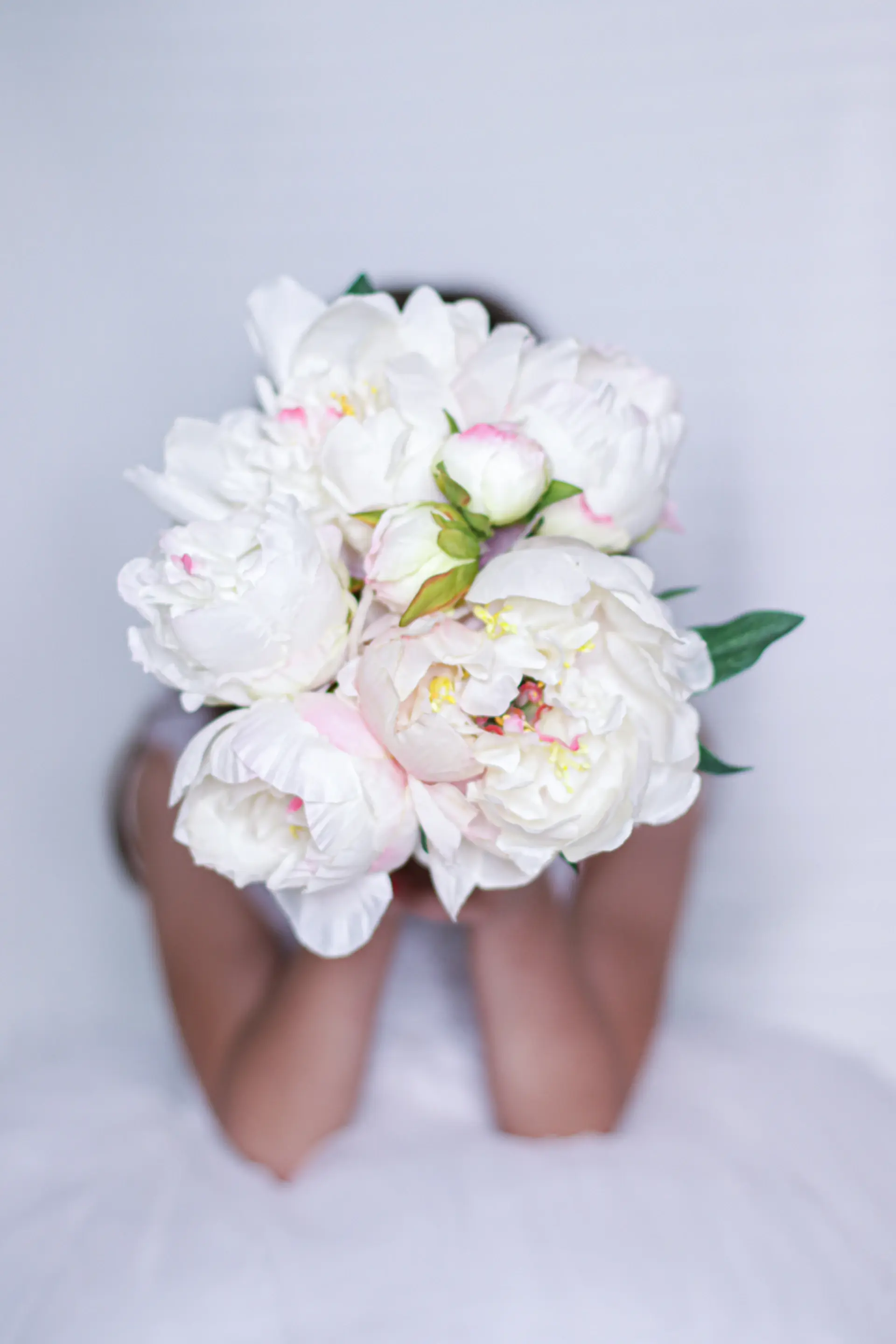Bride holding ivory peony bouquet