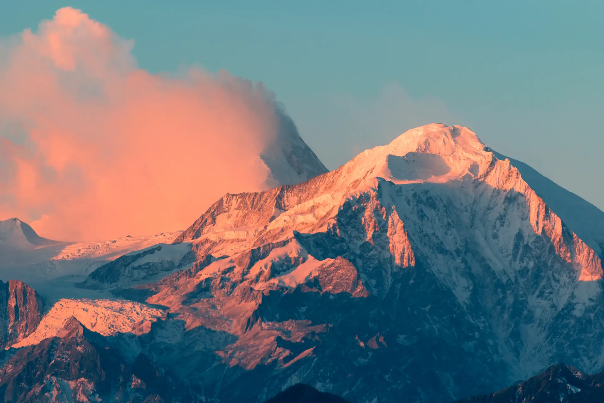 Granite peak catching first sun above a sea of cloud