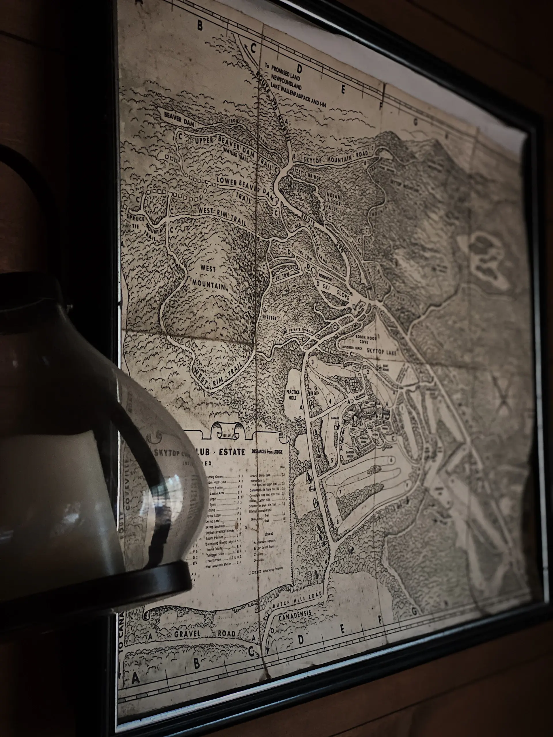 Founder studying a hand-drawn map by candlelight