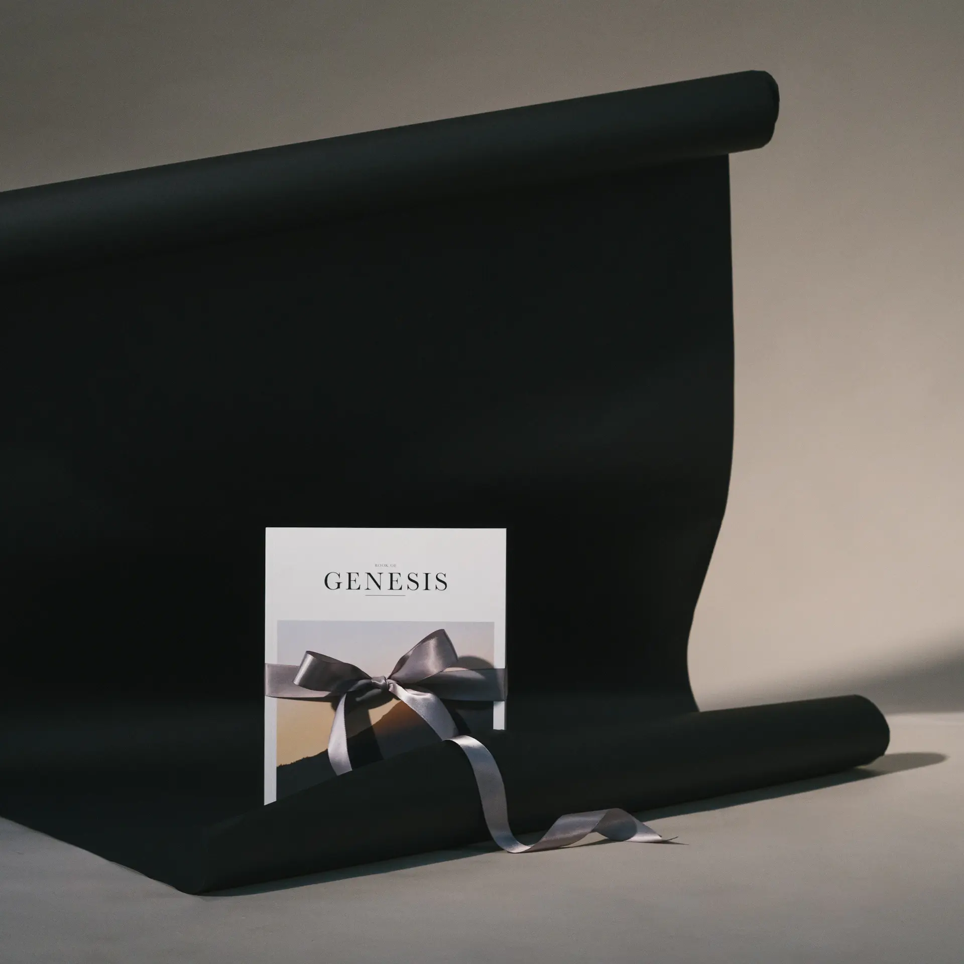 A handwritten personalised card resting beside a gift box