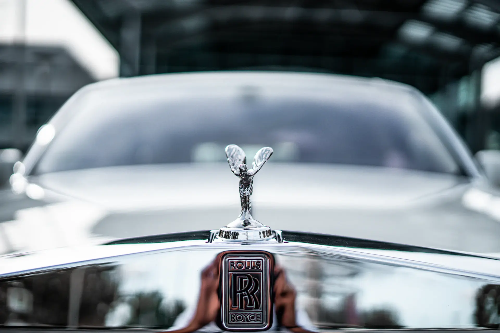 Engraved metal marque badge on a luxury car