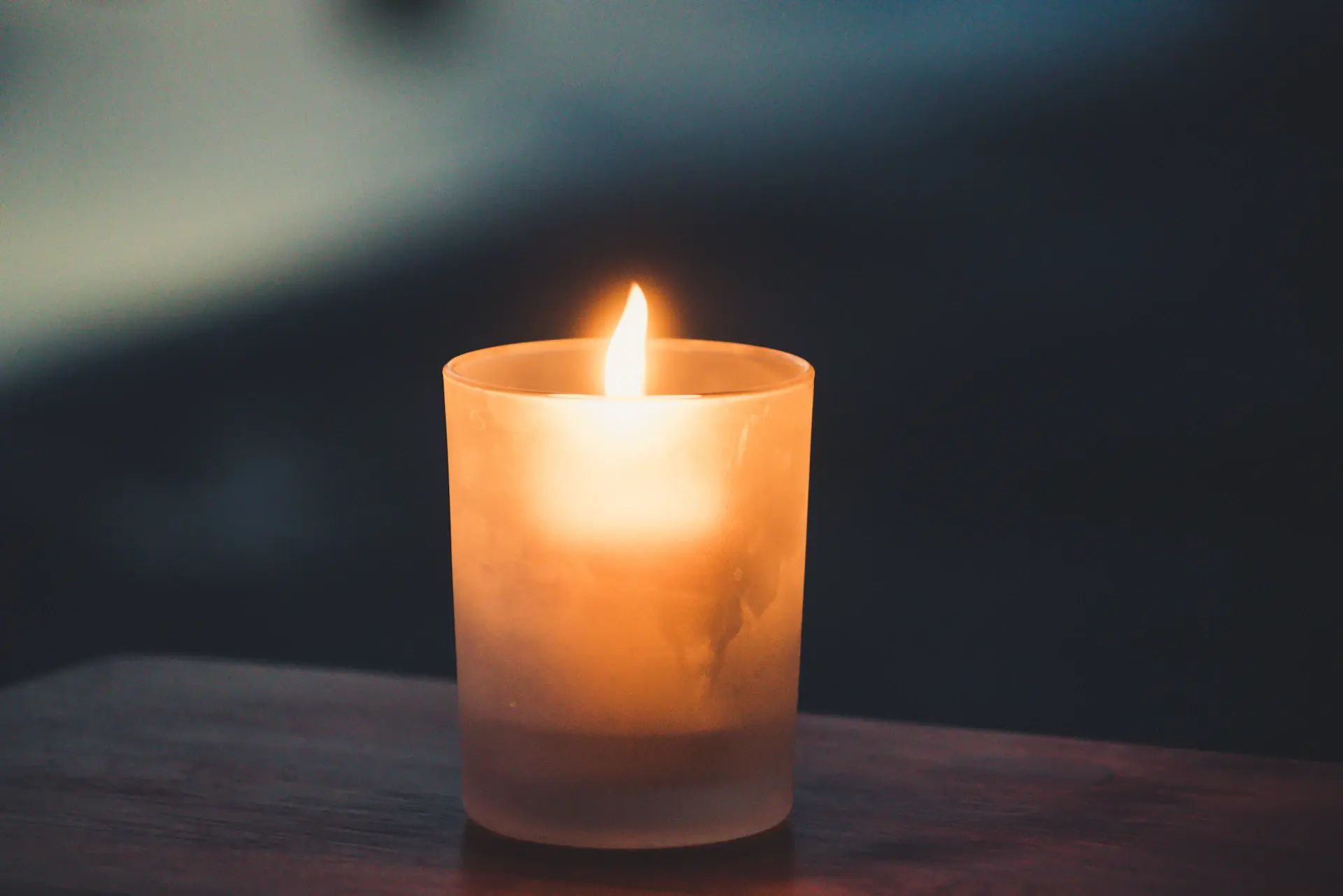 Close detail of a candle flame in soft golden light
